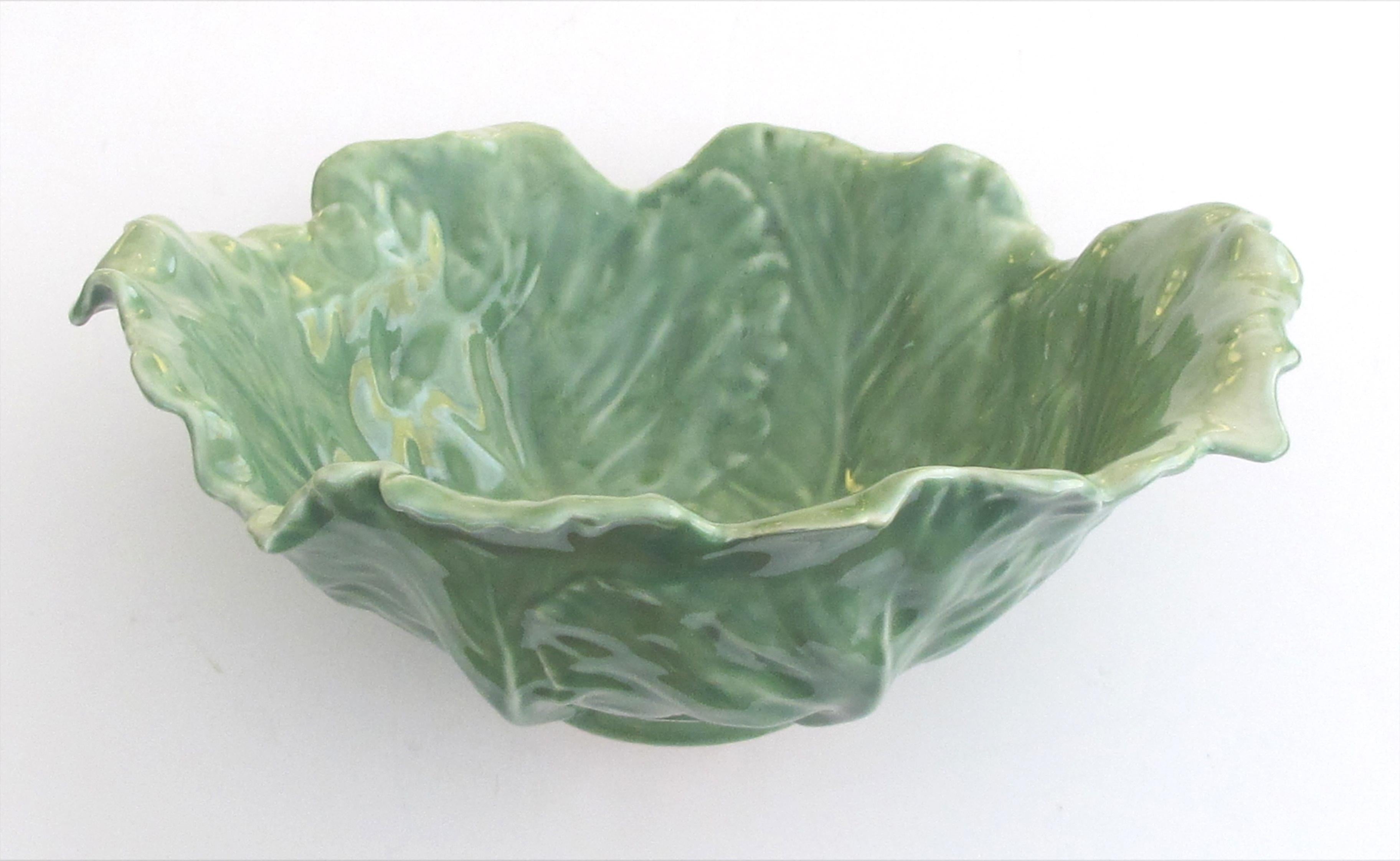 Impressed with Rookwood flame mark; the well-detailed deep bowl depicting large overlapping cabbage-leaves with flared undulating rim all tapering to a short foot; Rookwood has the distinction of being the first manufacturing company in the United