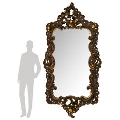 A large scaled Italian early 19th century Baroque st. Walnut and Giltwood mirror