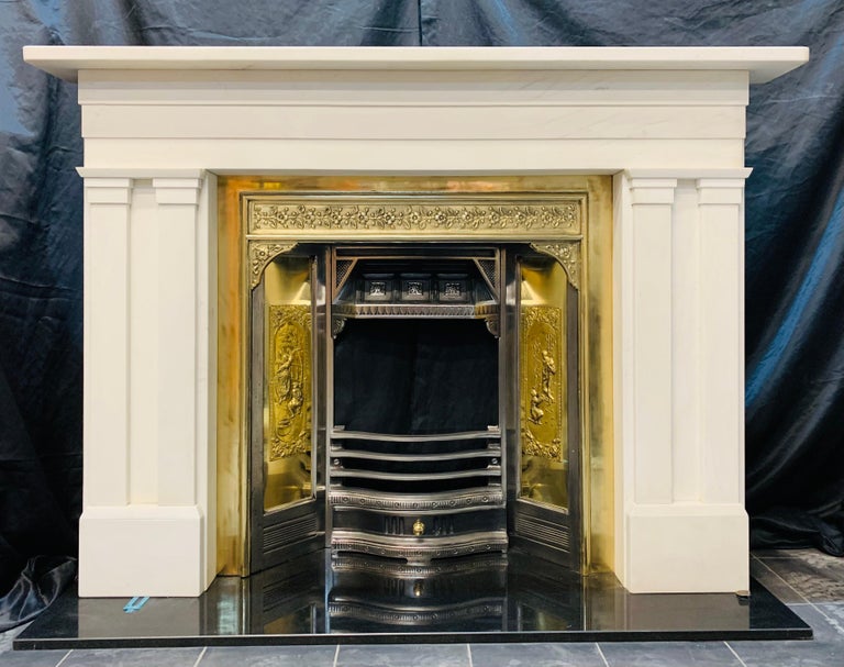 A large and elegant Scottish, lightly veined statuary marble fireplace surround in the manner of William IV. A generous top shelf with rounded corners sits above a stepped full length frieze, supported on splayed capping with channel set jambs,