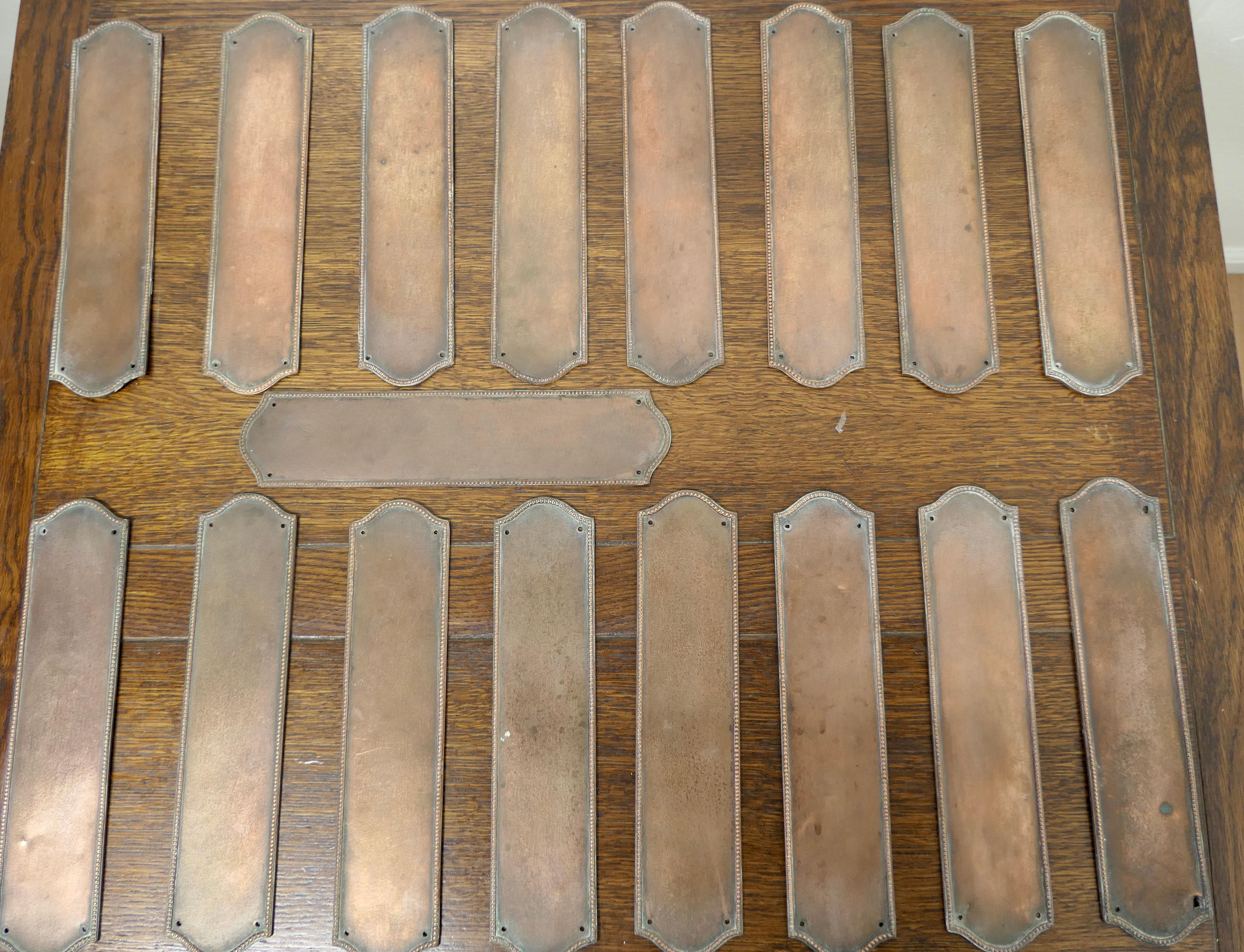 A large set of 19th century copper bronze door finger plates 

There are 17 identical pieces in this set, the are very heavy and made in bronze which has a slightly copper colour, the top and bottom are shaped and there is a a raised decoration
