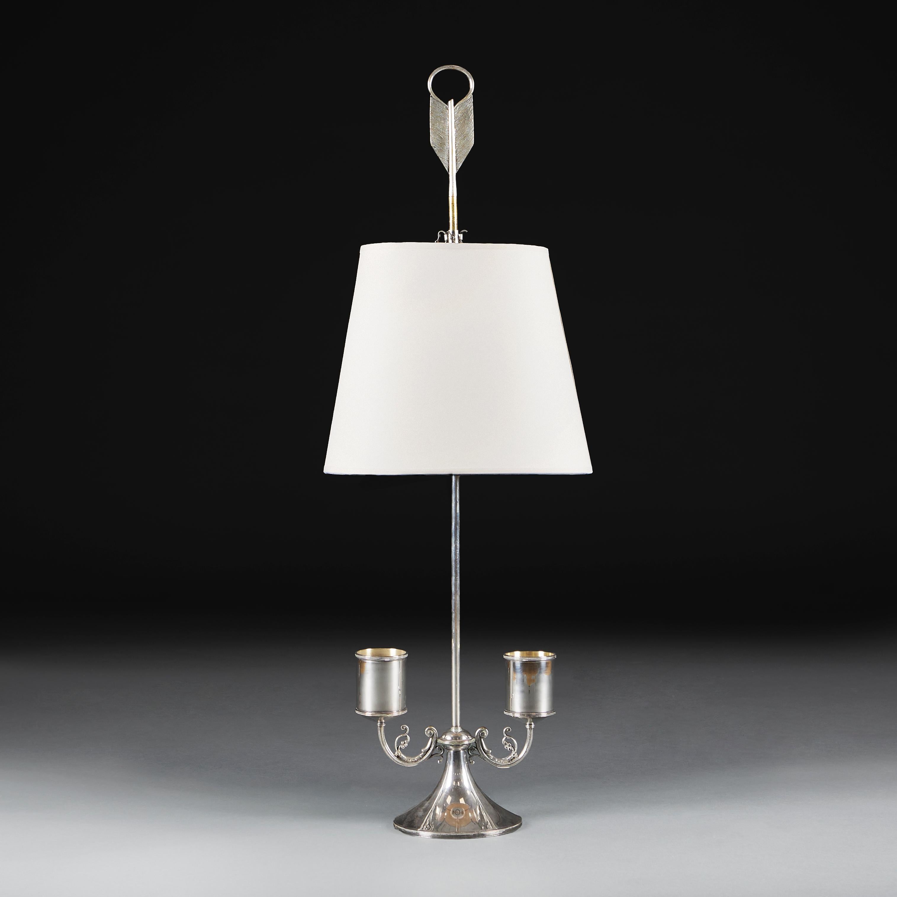 A fine silver bouillotte lamp of large scale, with loop and arrow top, with adjustable shade height, supported on a pedestal base with scrolling arms. Stamped Avanti. 

Avanti was founded in 1929 and became a major part of the Italian design