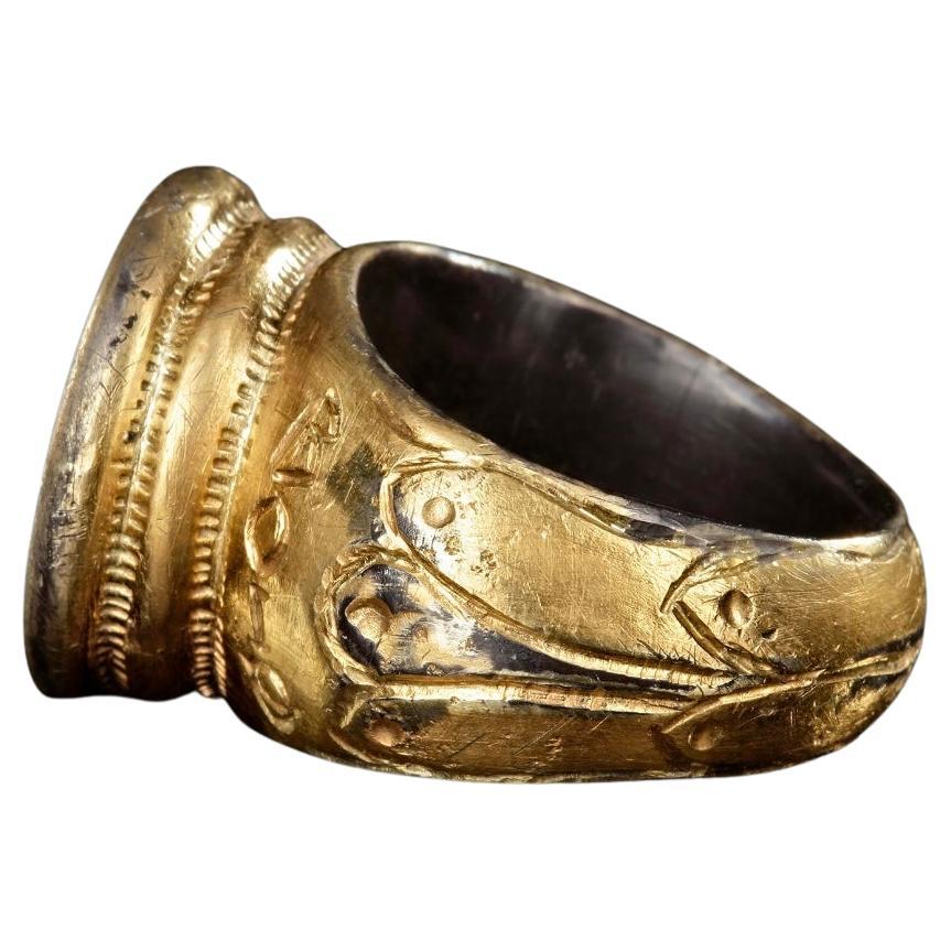A large silver gilt Byzantine ring from the middle to later Empire. The bezel shows saints Peter and Paul standing by a processional cross, both holding bibles. Note the shoulders of the cross are the words 