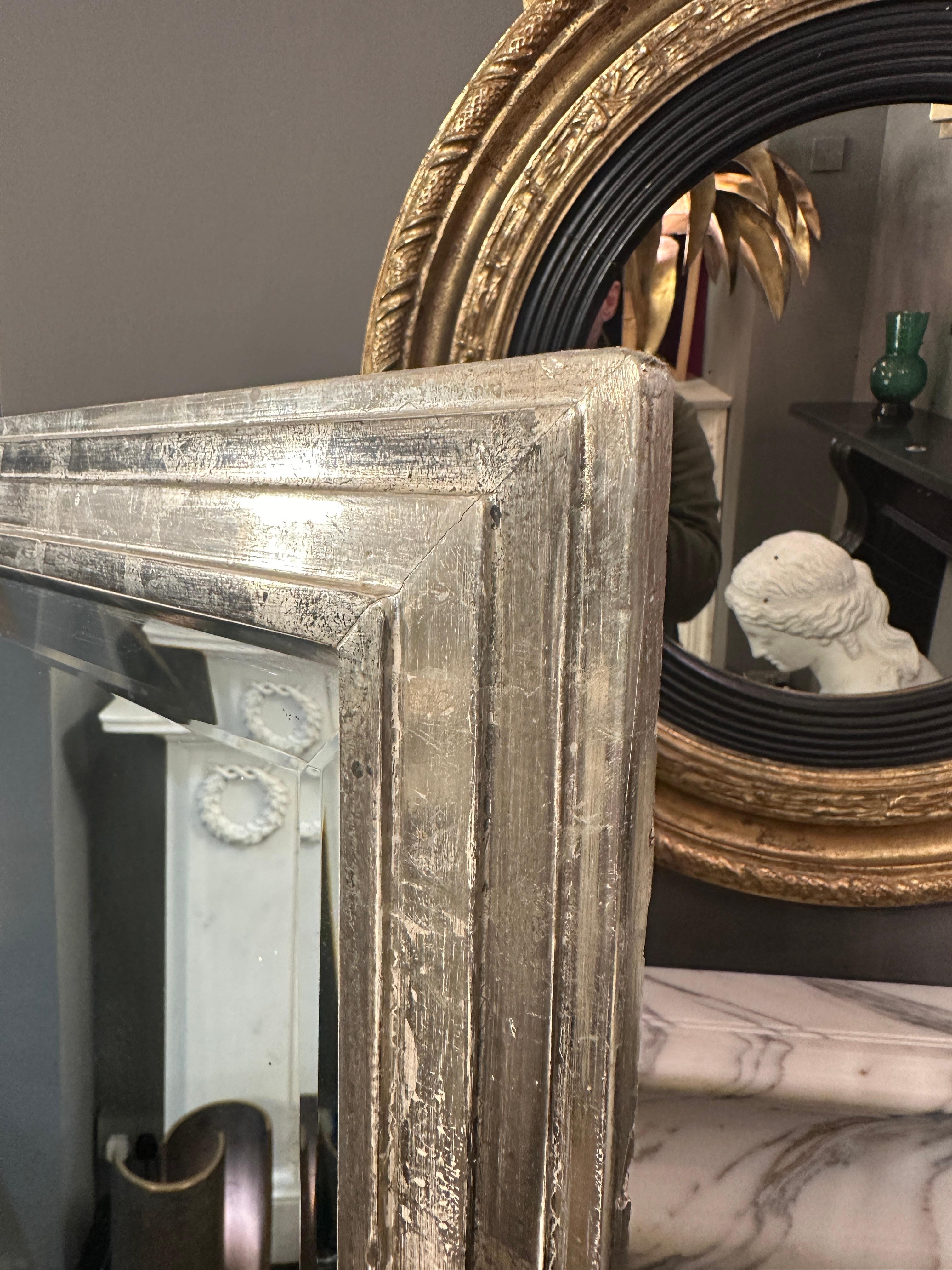 A Large Silver gilt Bistro mirror with stepped bordered frame and bevelled plate mirror glass. Boarded back. Soft patinated gilt work giving warm toned finish. Mirror glass is clear of foxing and is in good condition. 

French Circa 1970 