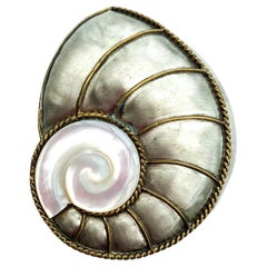A large silvered metal and resin 'nautillus shell' brooch, Fabrice, Paris, 2000s
