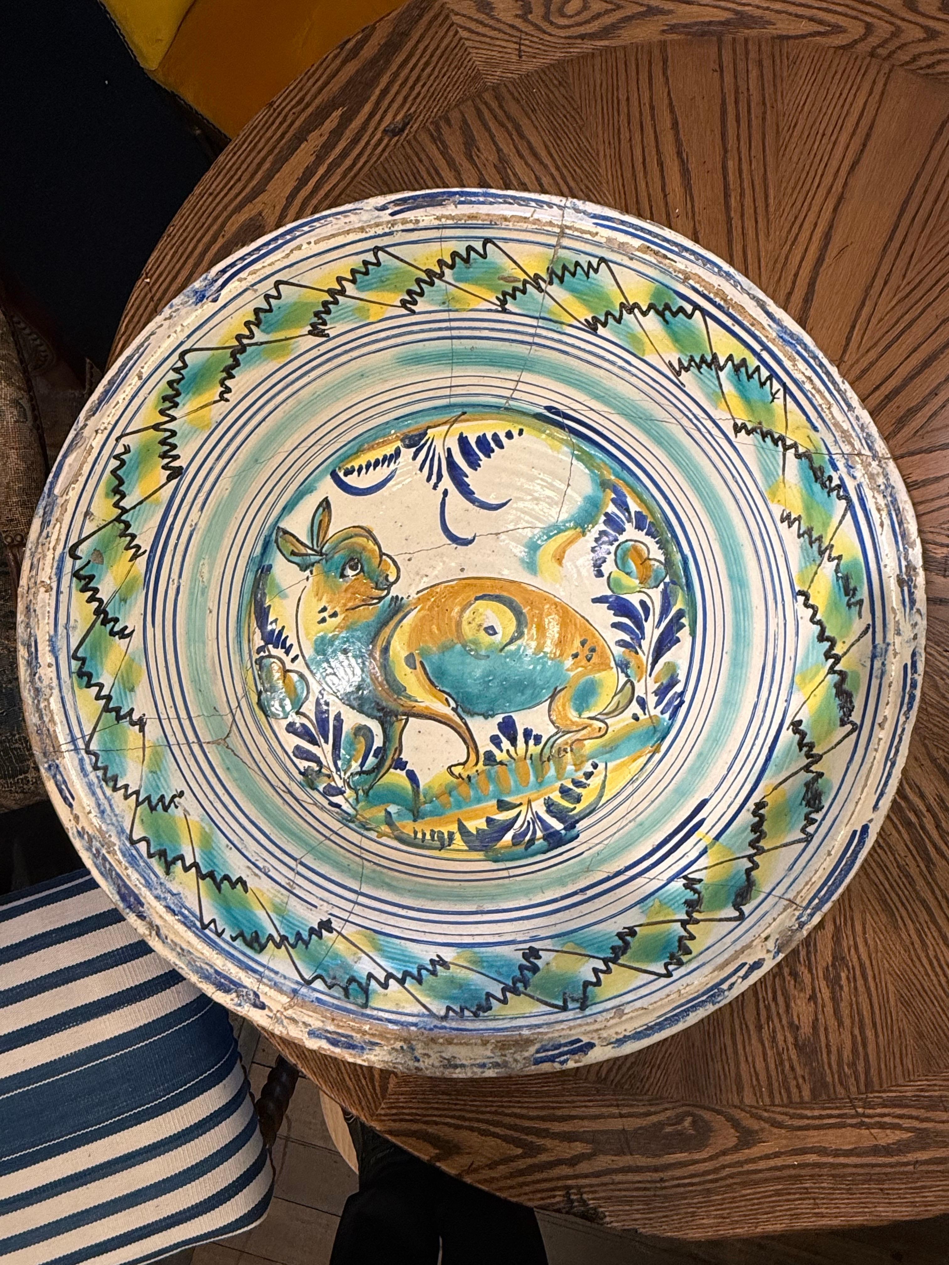 A Large Spanish Hand Painted Lebrillo Bowl, 19th Century

Description:
A Large hand-built terracotta bowl with rabbit motif to the tondo within a banded rim, underglaze painted in turquoise, yellow and blue.

Provenance: Private Australian