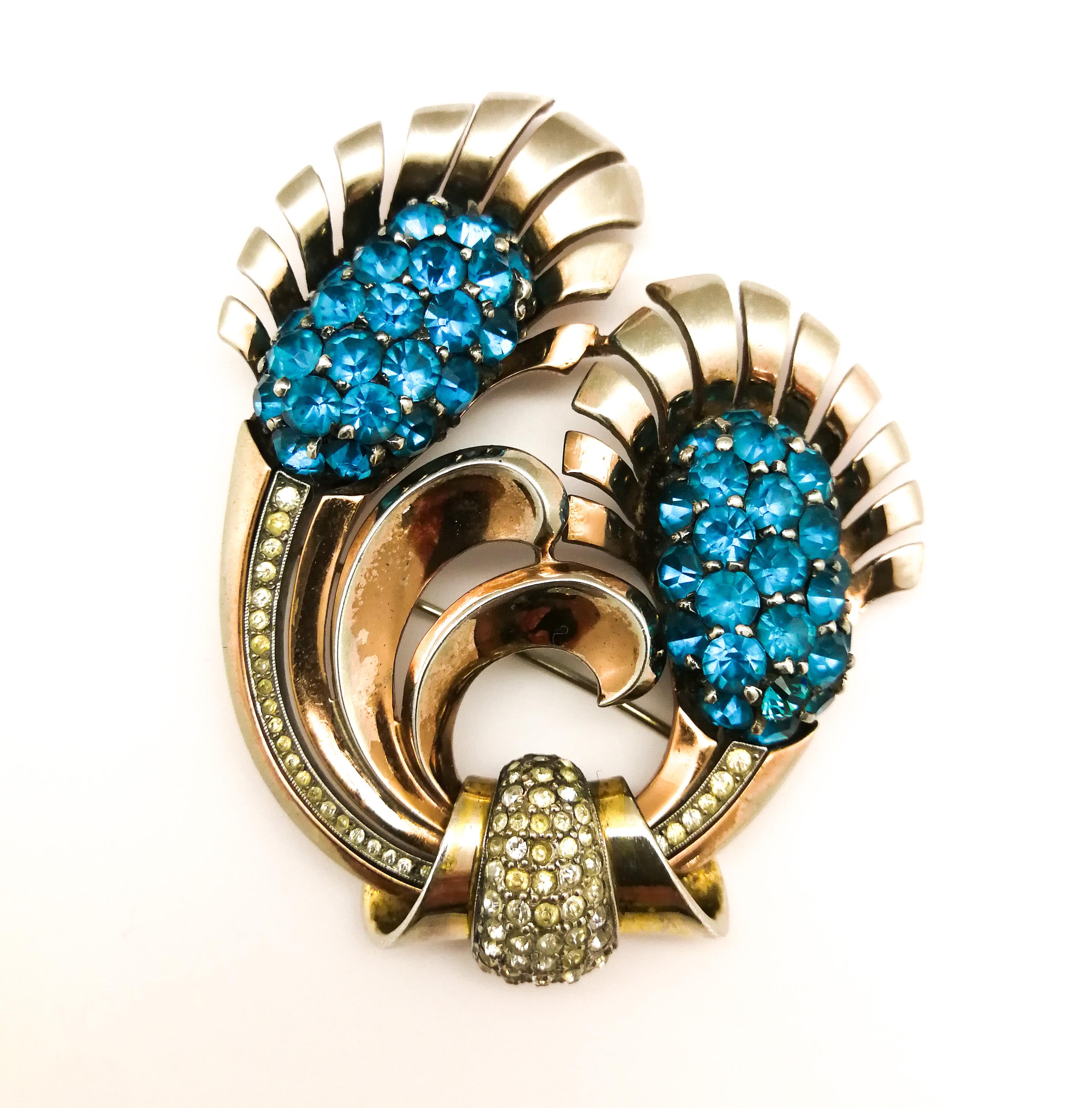 This beautifully designed and created brooch by Pennino in the 1940s epitomises the 'cocktail style' so prevalent at this time, a true flight of fancy and imagination. Beautifully executed in sterling silver, with a gold wash, the unique blue stones