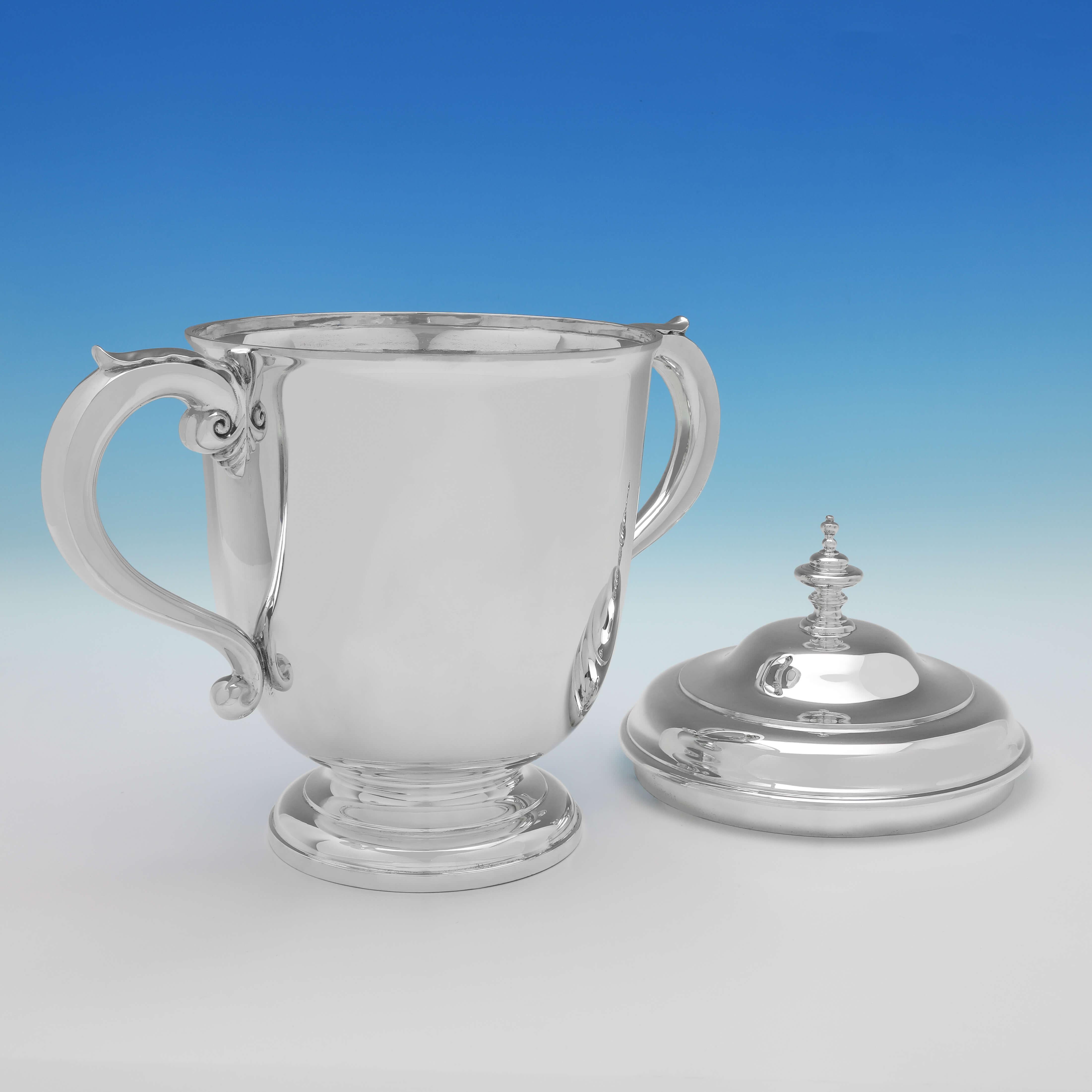 Hallmarked in London in 1935 by Mappin & Webb, this very handsome, large, sterling silver trophy, features acanthus detailed handles, and is otherwise plain in style. The trophy measures: 15