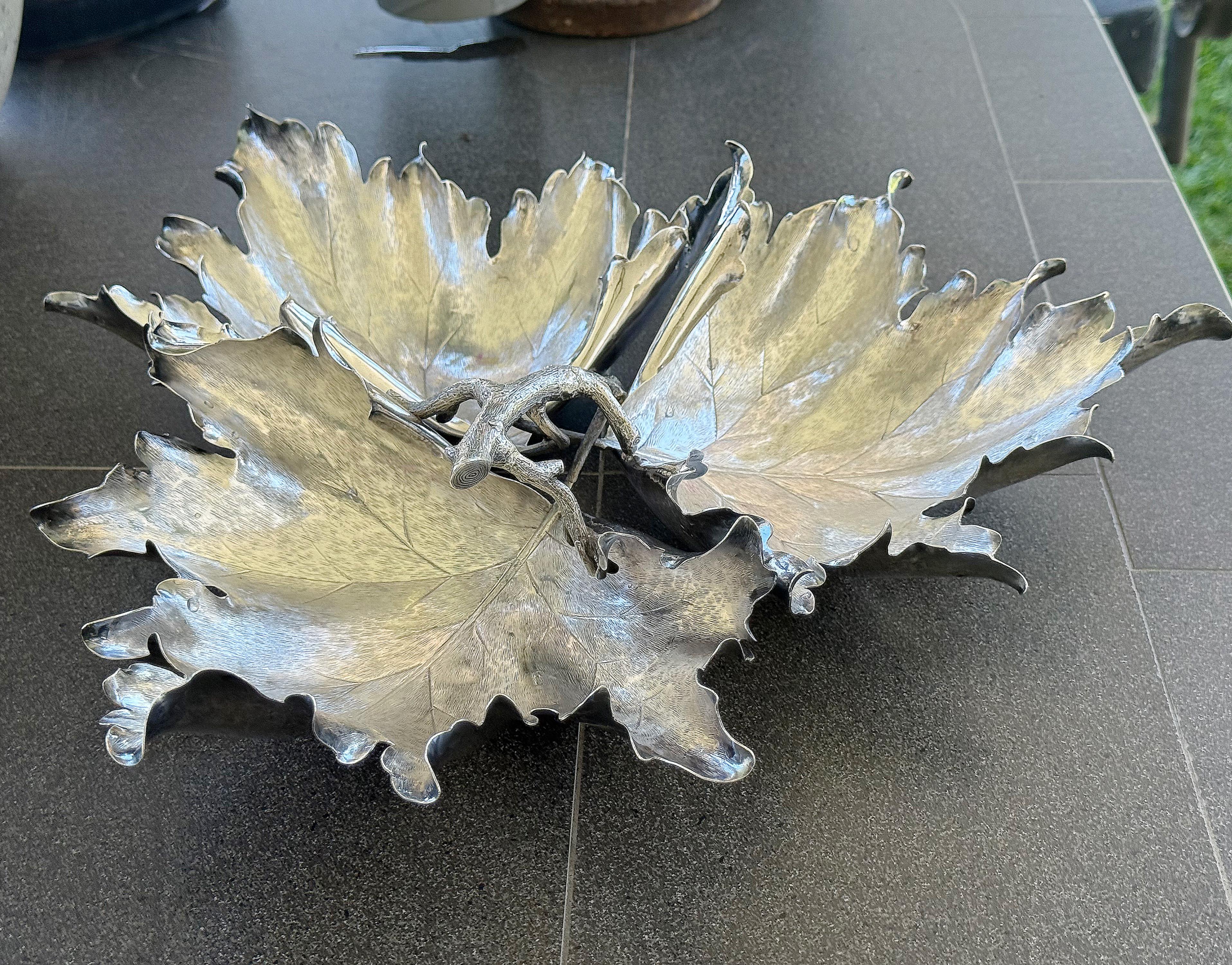 A rare large maple leaf sterling silver centerpiece created by the famous Italian silversmith Buccellati, twentieth century. The centerpiece is composed of three large finely chiseled silver leaves of approximately 10