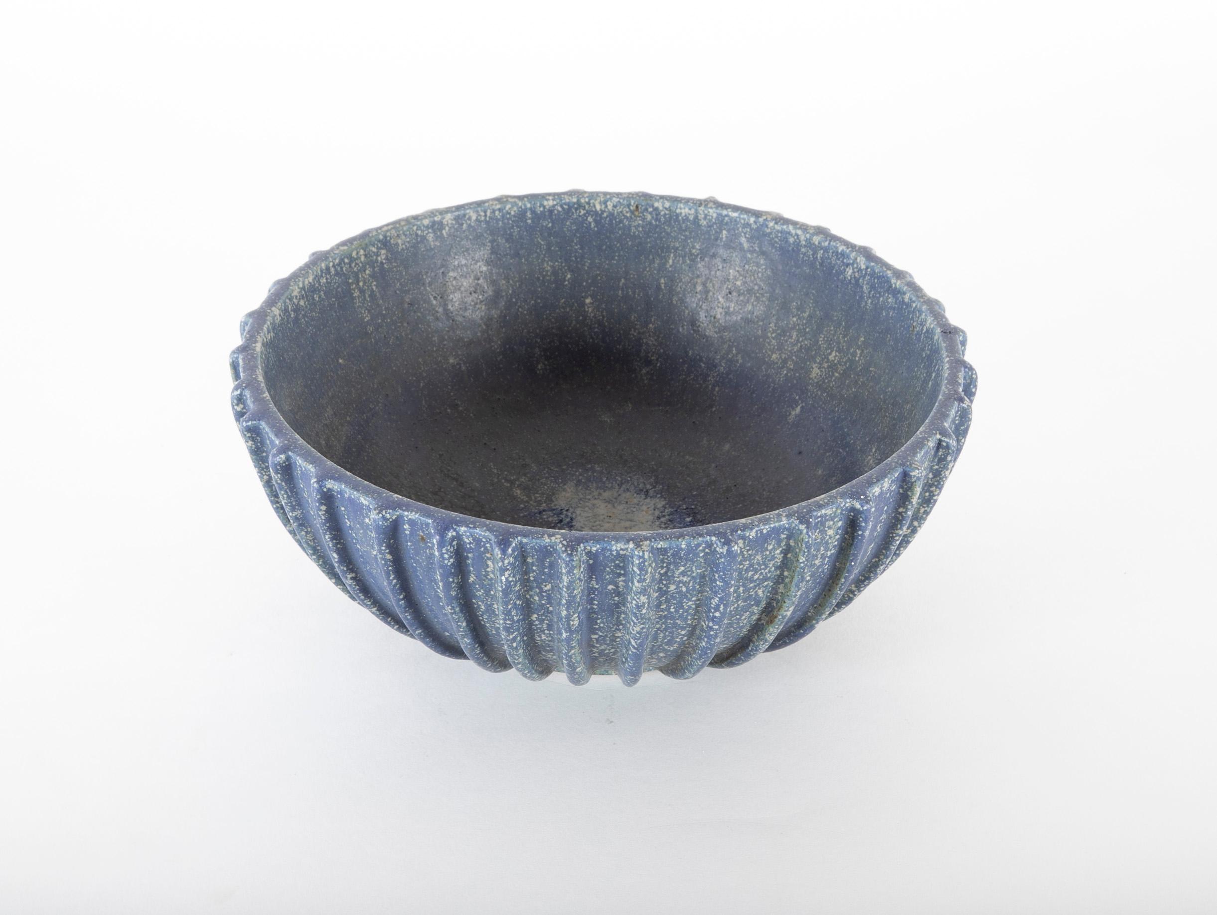 A stoneware bowl made by Arne Bang circa 1960s decorated with blue glaze. Signed AB 114.