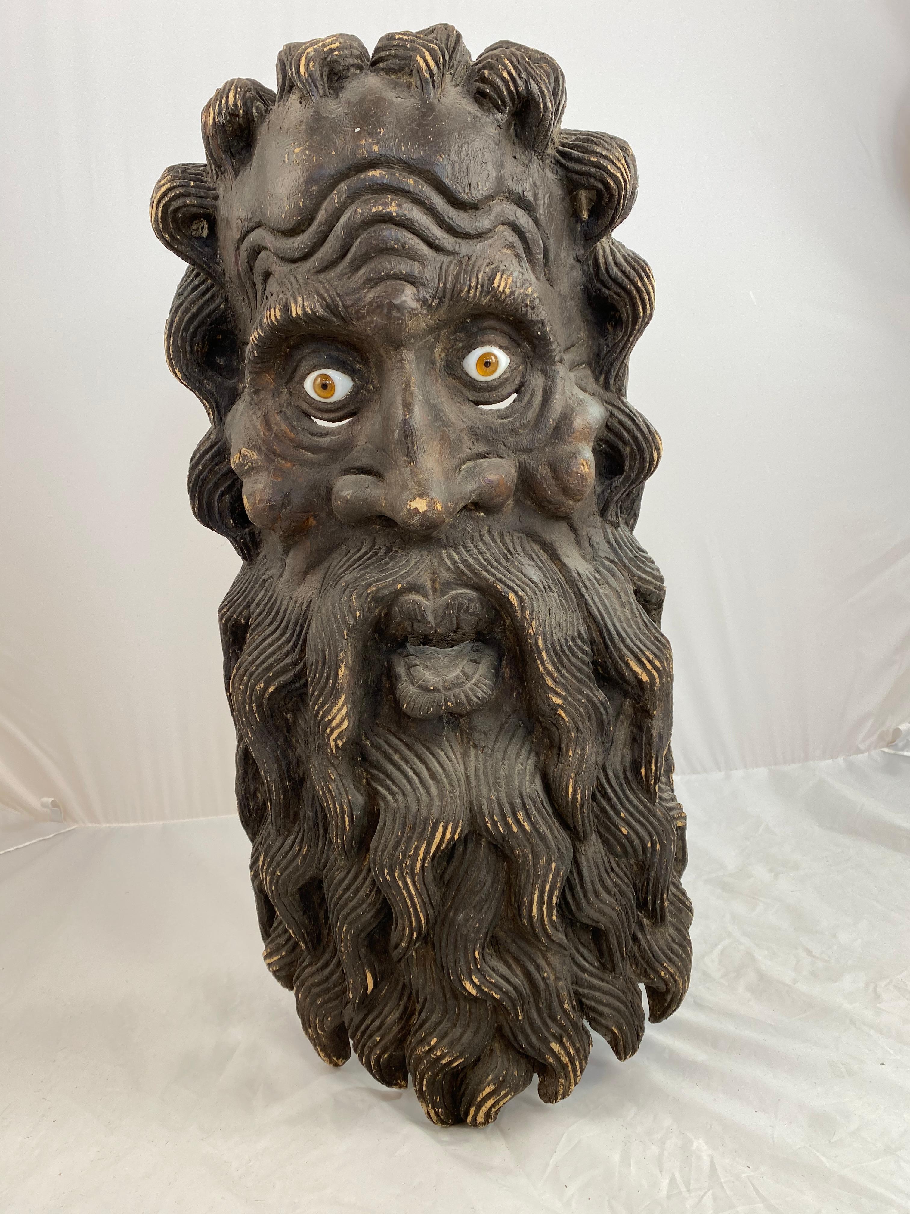 A large and interesting 19th c theatrical wooden mask. Sculptured of wood with great skill and inlayed with glass eyes. He looks somewhat crazy but with a great sense of humour.
