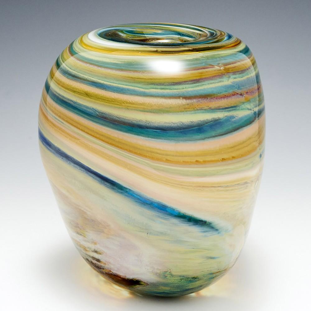 Heading : A large Triform storm clouds vase by Siddy Langley
Date : 2021
Origin : Cullompton, Devon
Bowl Features : Dimpled triangular cross-section. Striated polychrome bands that transition into sweeping undulating clouds
Marks : Signed and