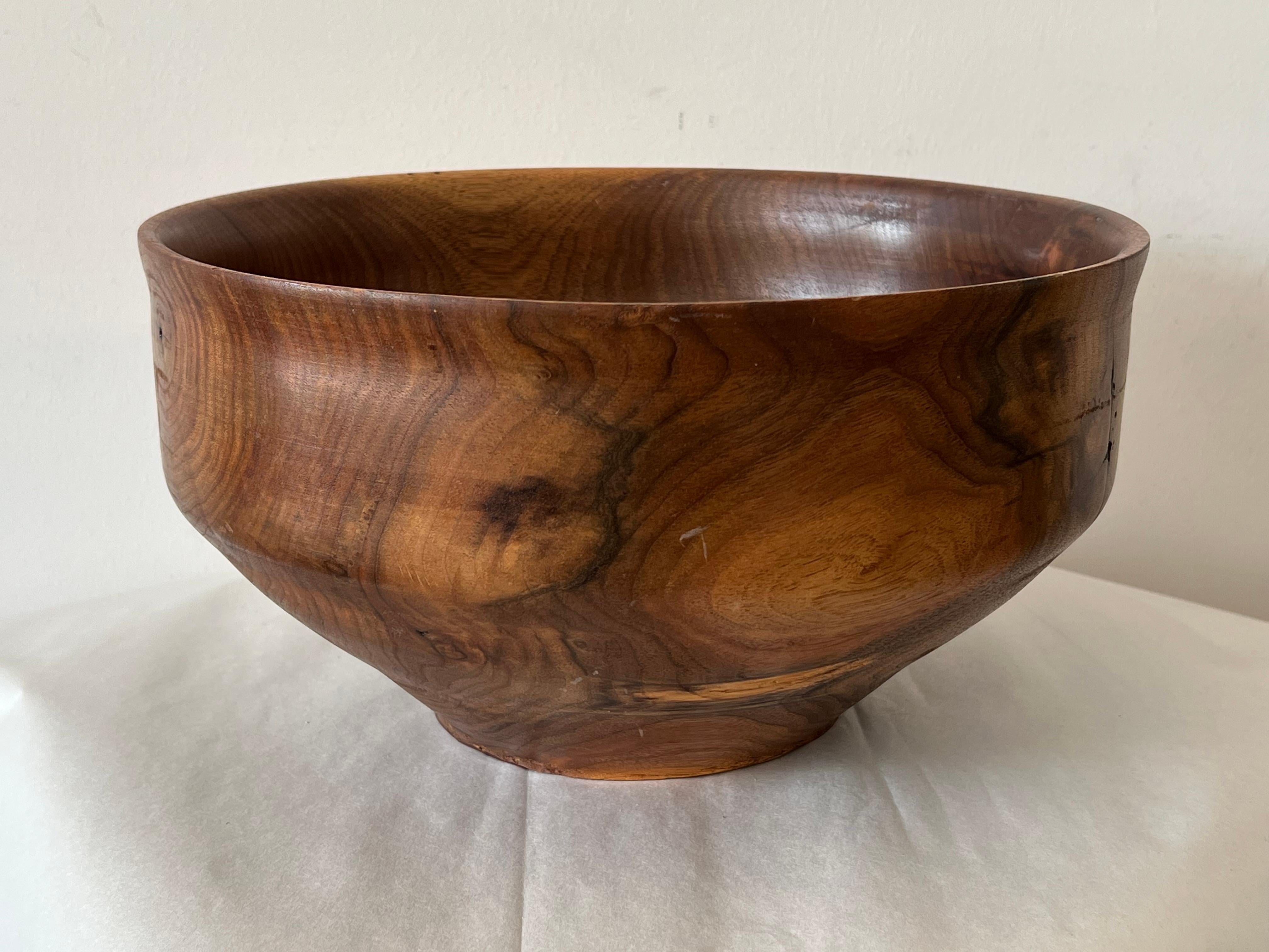 A large turned walnut bowl by a self taught crafstman Paul Edward Schweisthal (1941-2024). Active in Virginia, here is a note that gives a a better understanding of his woodworking methods:
