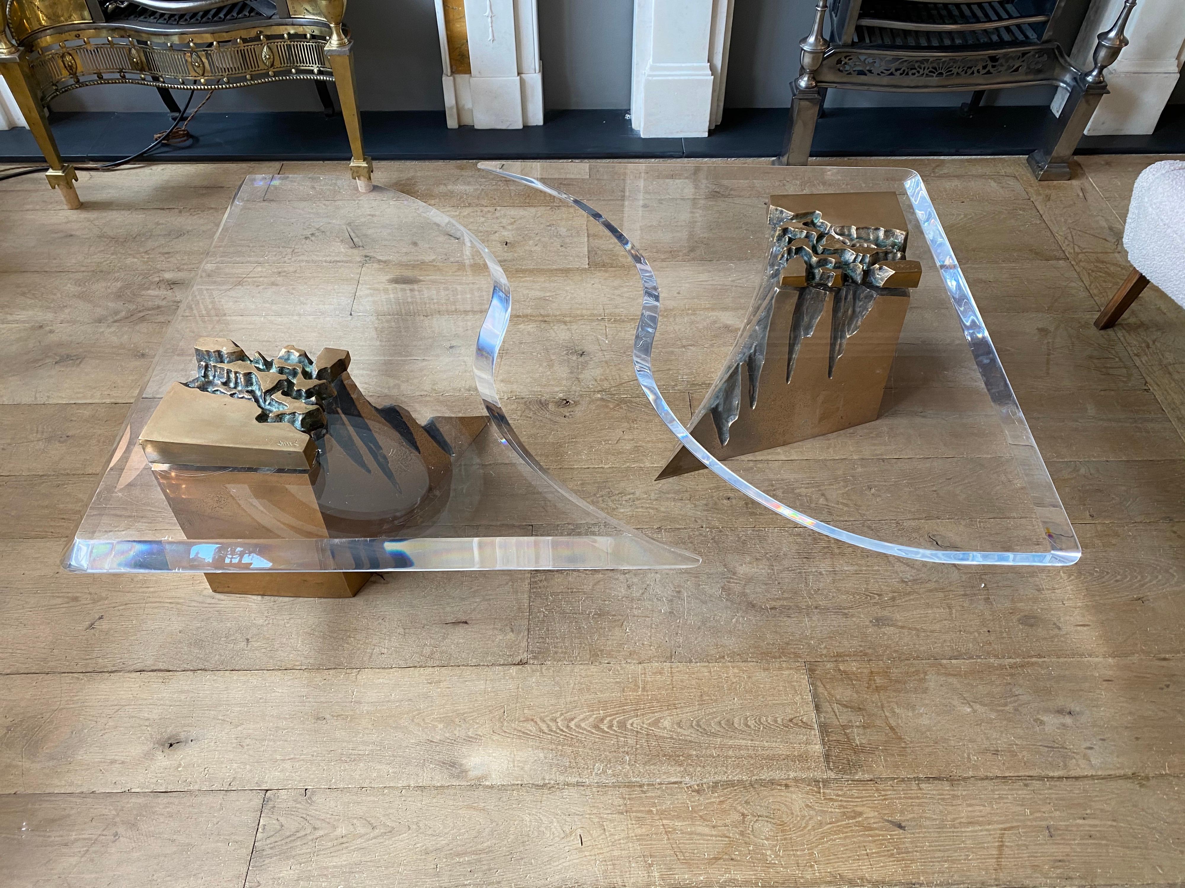 An unusual two-piece brass and Lucite coffee table, with moulded edge and curved shape with two organic cast brass supports signed by designer. Can be pushed together or separated as shown in images.