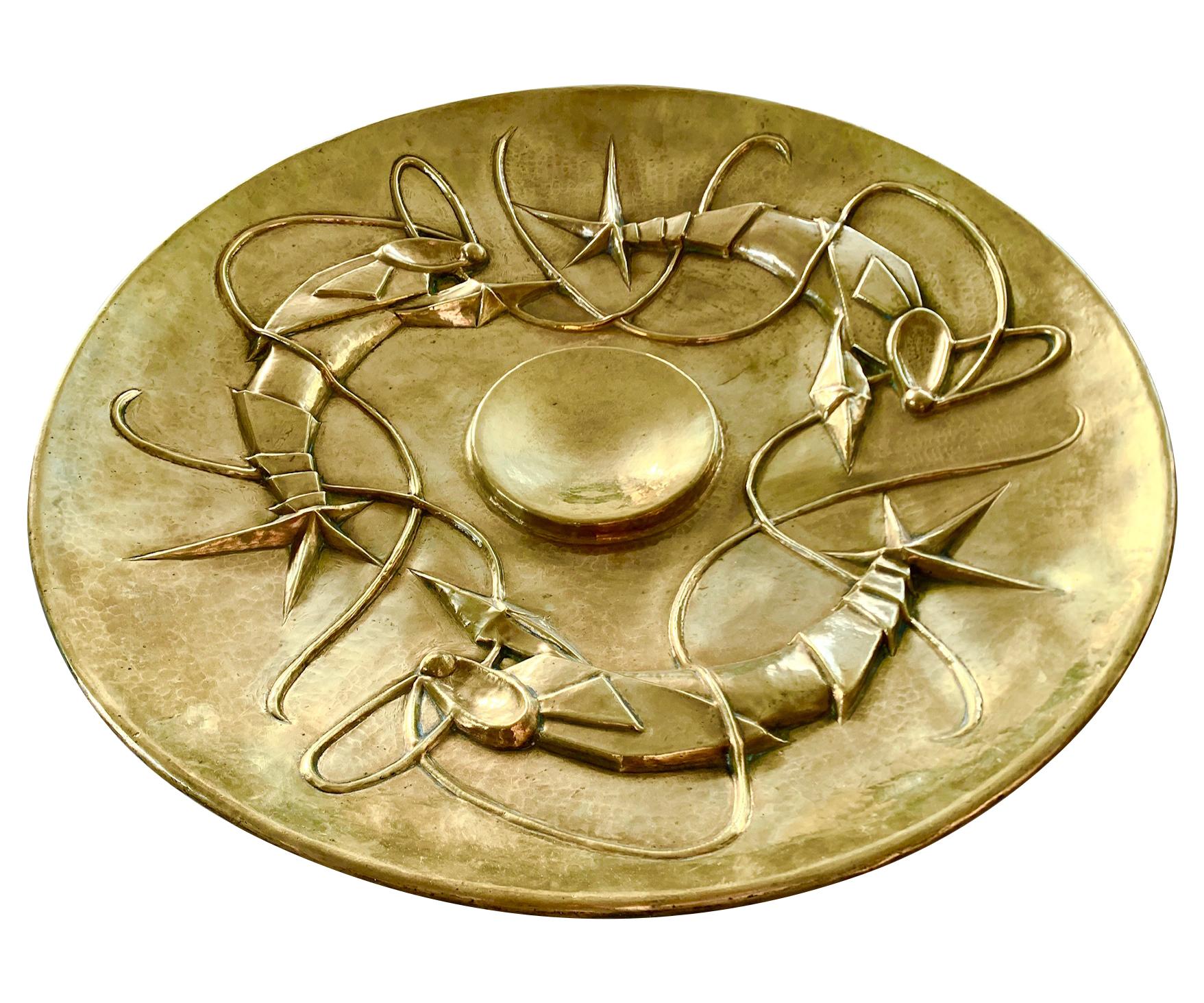 A lovely large unique Art Nouveau brass charger decorated with three hand beaten stylized lobsters in relief around a central circle, very much in the Secessionist style.
Although it is signed on the reverse 