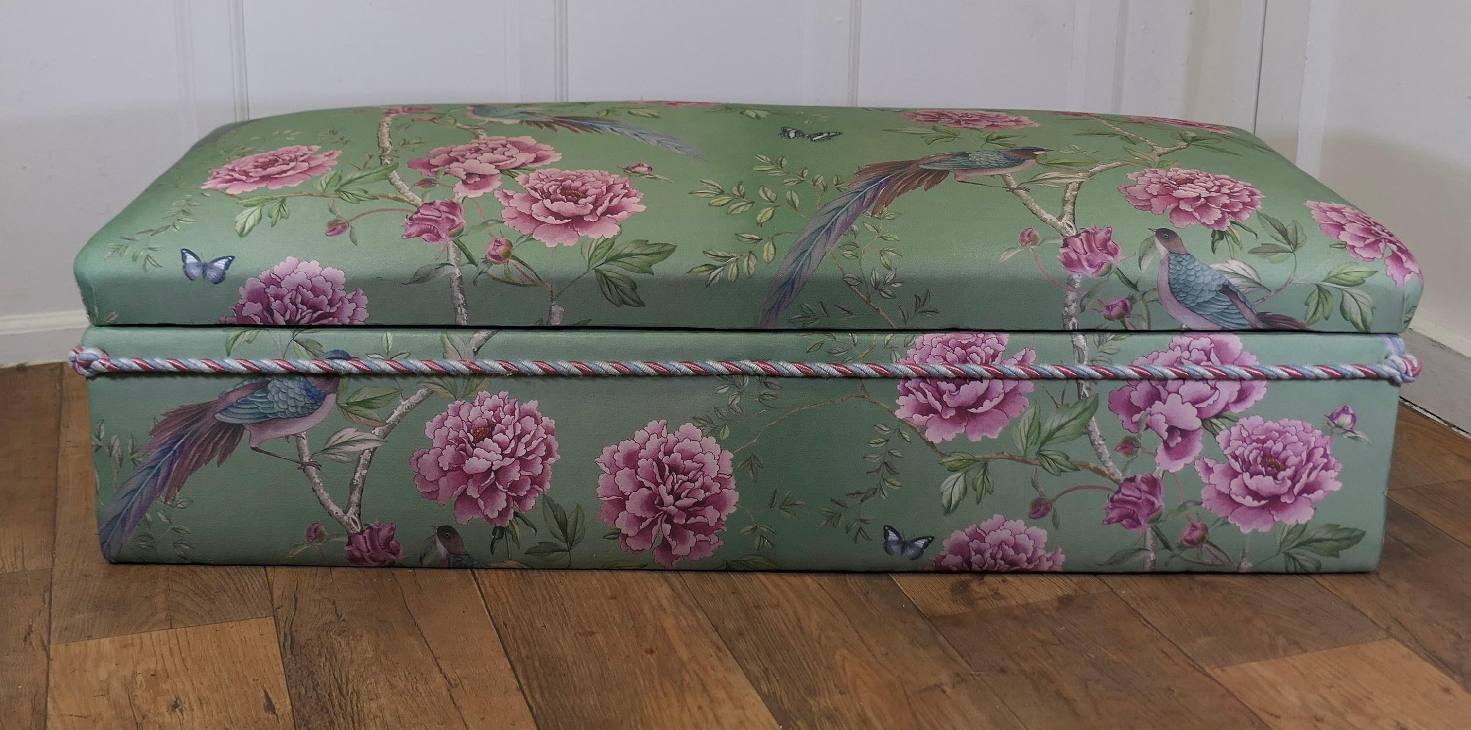 A Large Upholstered Ottoman or Window Seat 

This piece is upholstered with a beautiful chinoiserie designed linen fabric, it has a green background and is decorated with giant pink chrysanthemums and birds of paradise
The ottoman has been designed