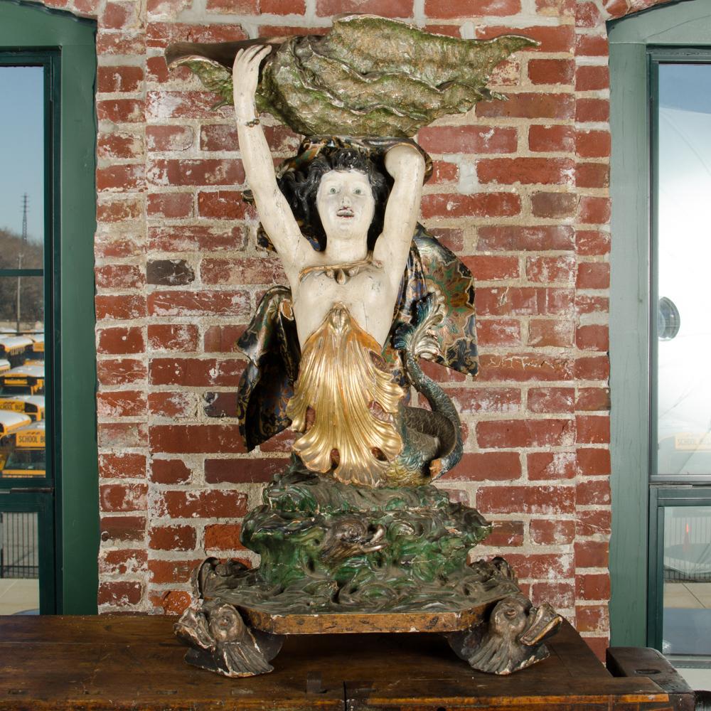 A rare Venetian sculpture of mermaid holding seashell over her head. Shell can function as bucket, dry flowers. 
Polychrome paint over carved wood, beautiful detail and original color.
Either a oversized tabletop sculpture but a perfect size for