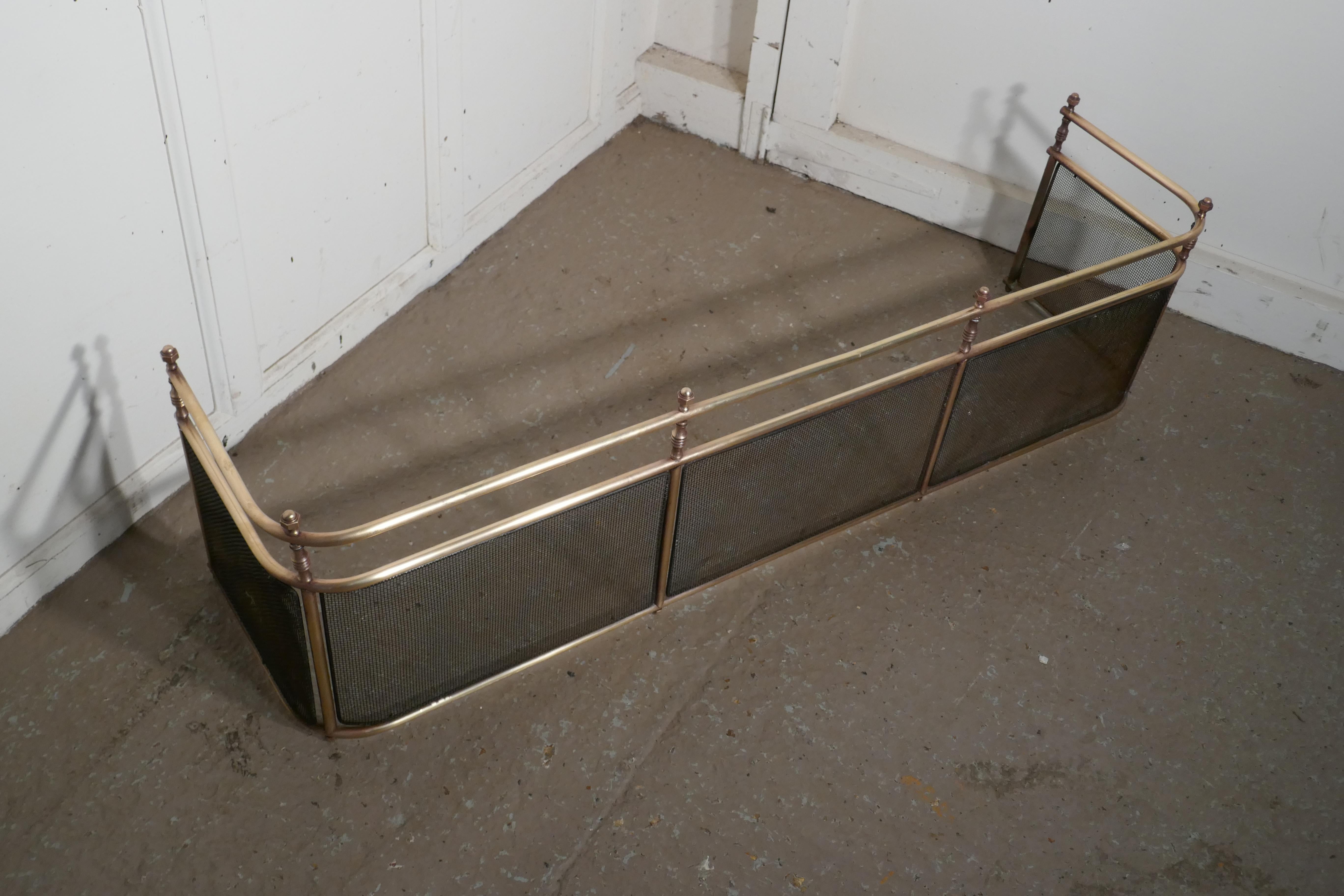 A large Victorian brass club fender 

This is a Victorian antique club fender often known as a nursery guard as it completely surrounds the fire. 
This Fender is top quality and very heavy it is made in solid brass, the fender has wire mesh