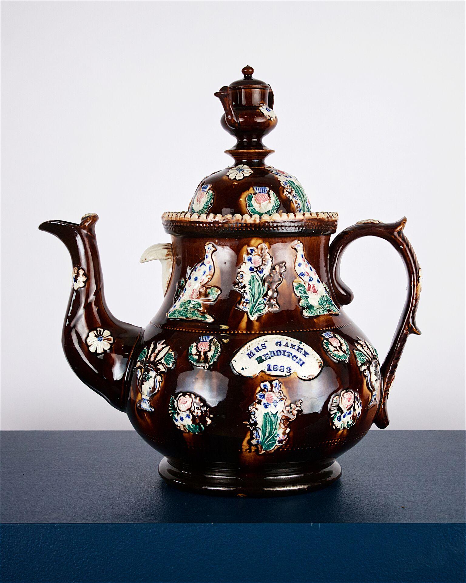 A large Victorian Measham bargeware teapot with the inscription “Mrs Gazzey, Redditch”. Very good condition overall, circa 1880.