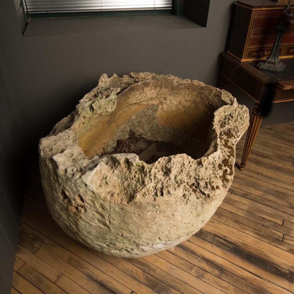 A large volcanic urn/planter with organic form, from Indonesia.
 Excavated from the ocean floor, volcanic urns comprise of a magma iron internal core surrounded by sedimented sand.