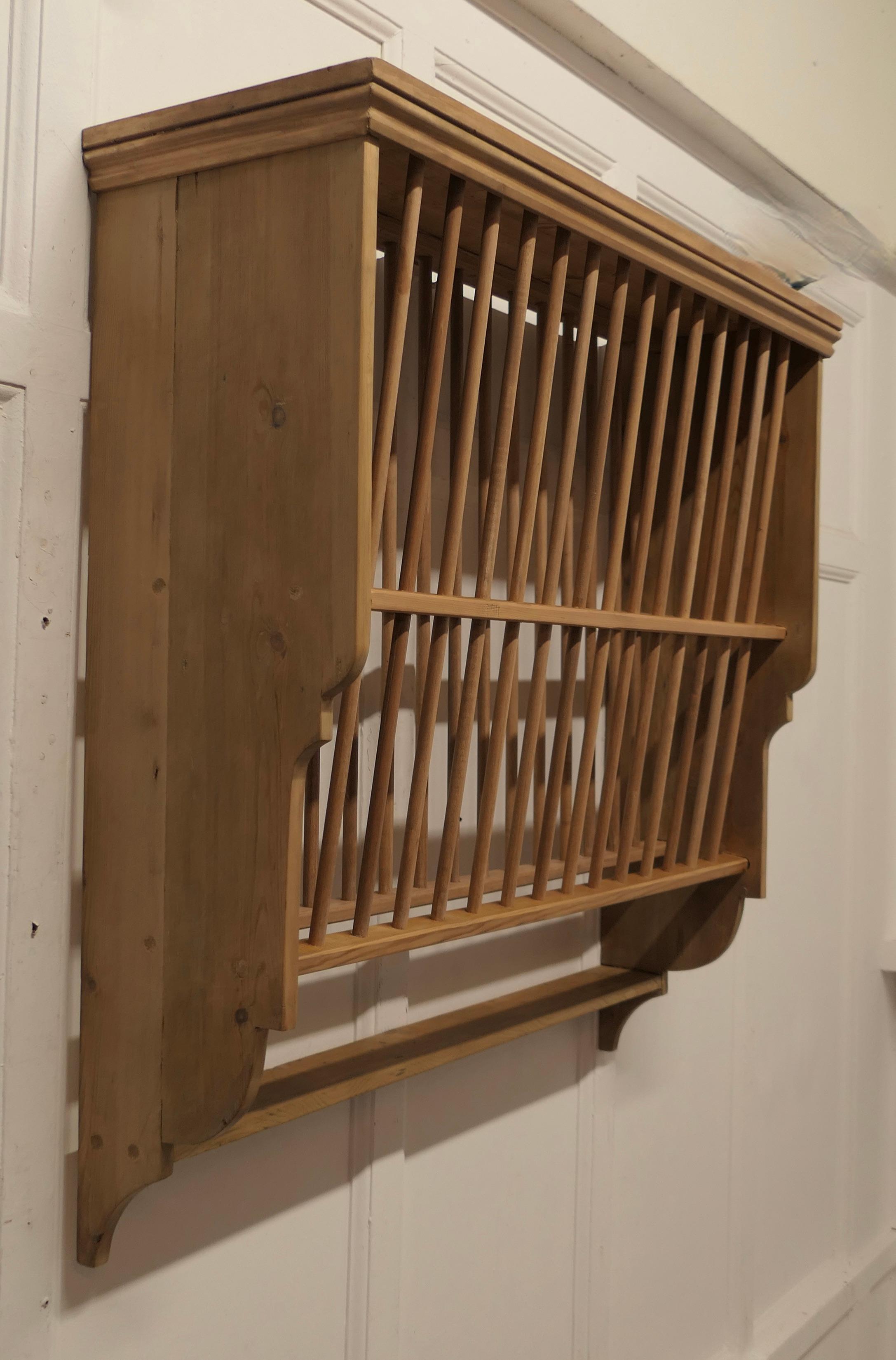 A Large Wall Hanging Pine Plate Rack


This useful piece hangs on the wall and drains and stores plates until required
It has a pine frame and wooden dowels with a waterfall shape, allowing 2 rows of plates to be stored at any one time, below there