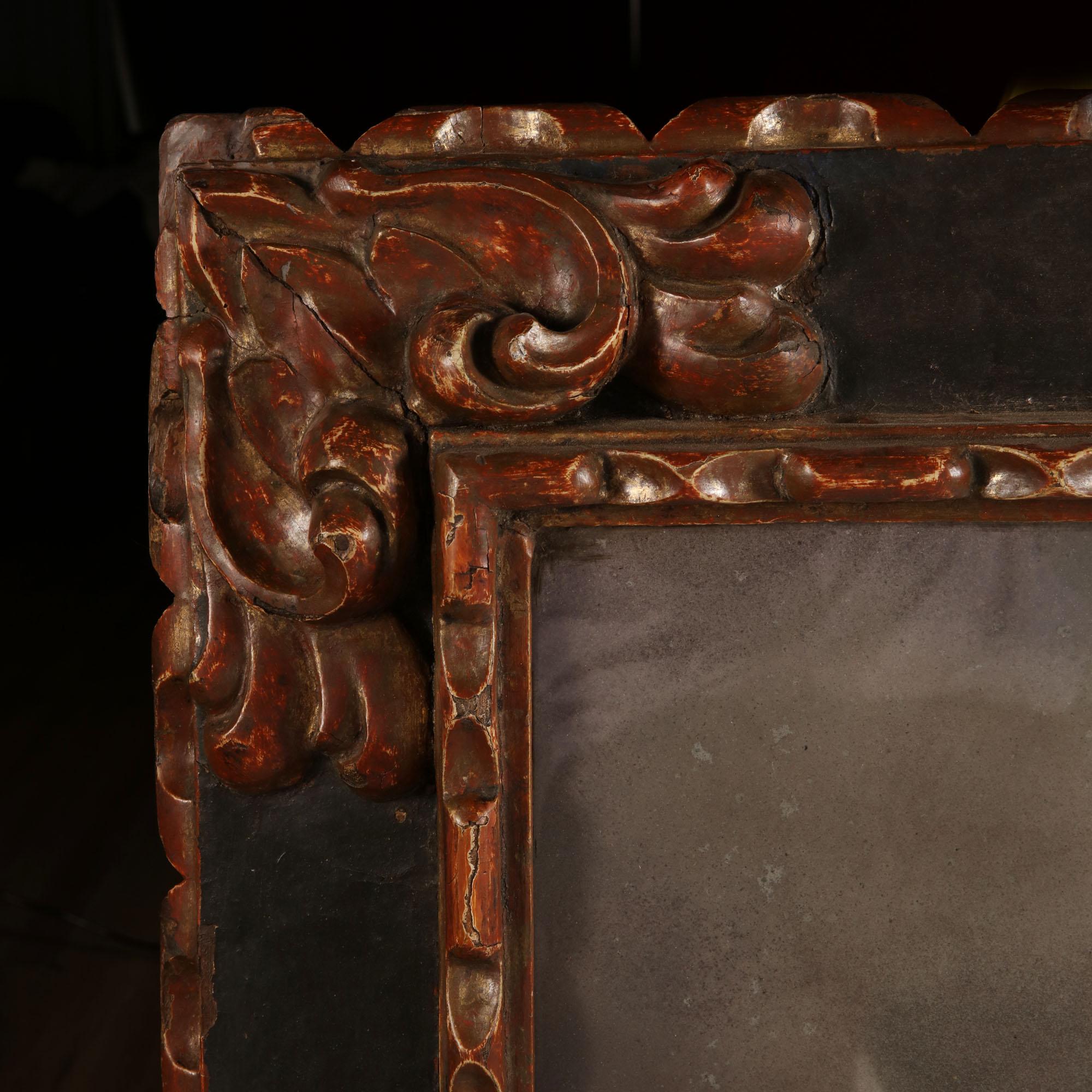 A late 17th century Spanish carved baroque mirror frame of large scale, with later mercury glass mirror plate.