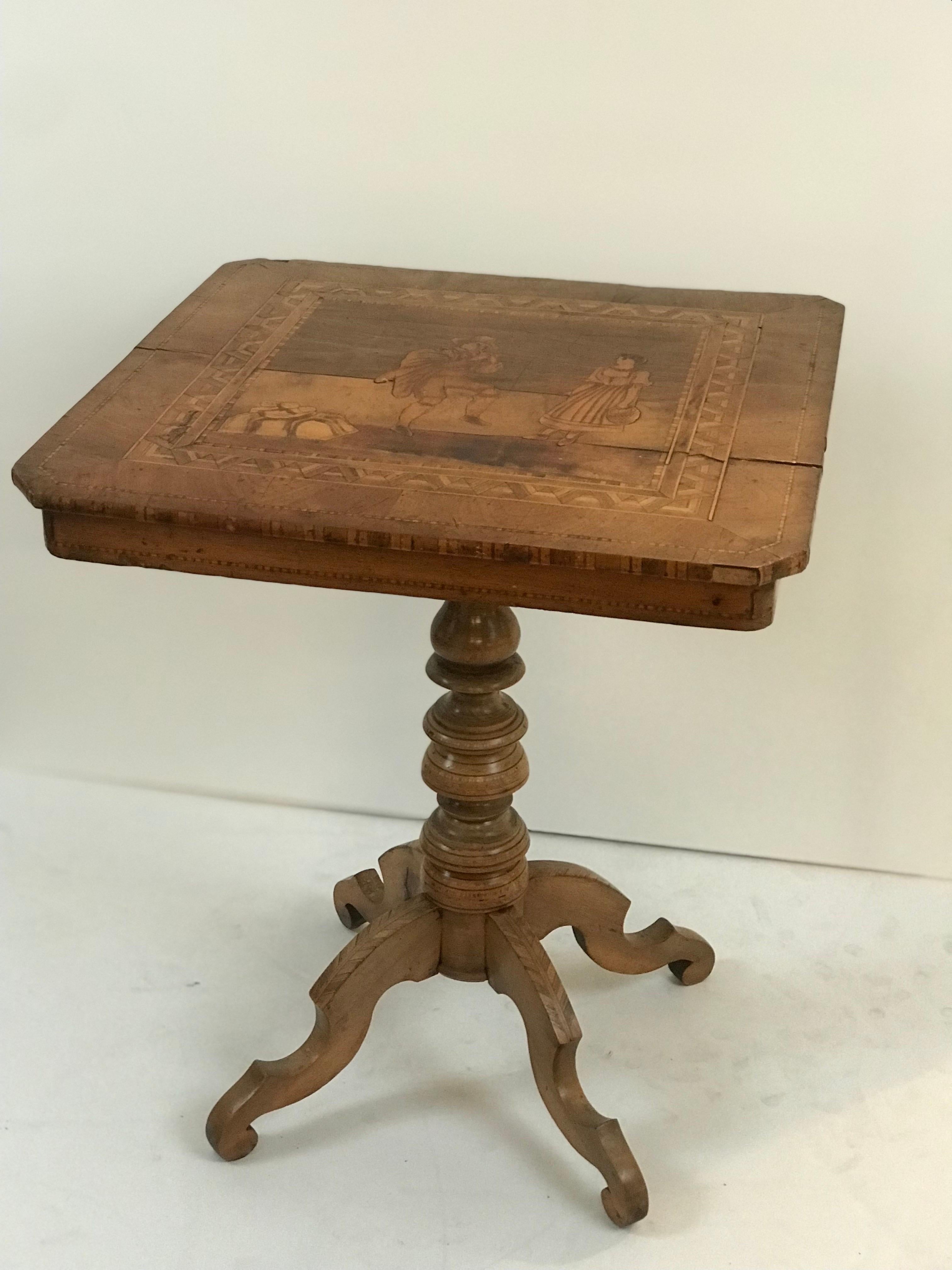 A highly decorative and complicated late 1800's Sorrento marquetry occasional table using a wide variety of woods and textures and featuring a center motif of a travelling minstrel in tradigital Renaissance attire serenading a milk maid playing his