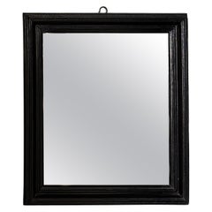An early 19th century black Mirror with Original Distressed Glass