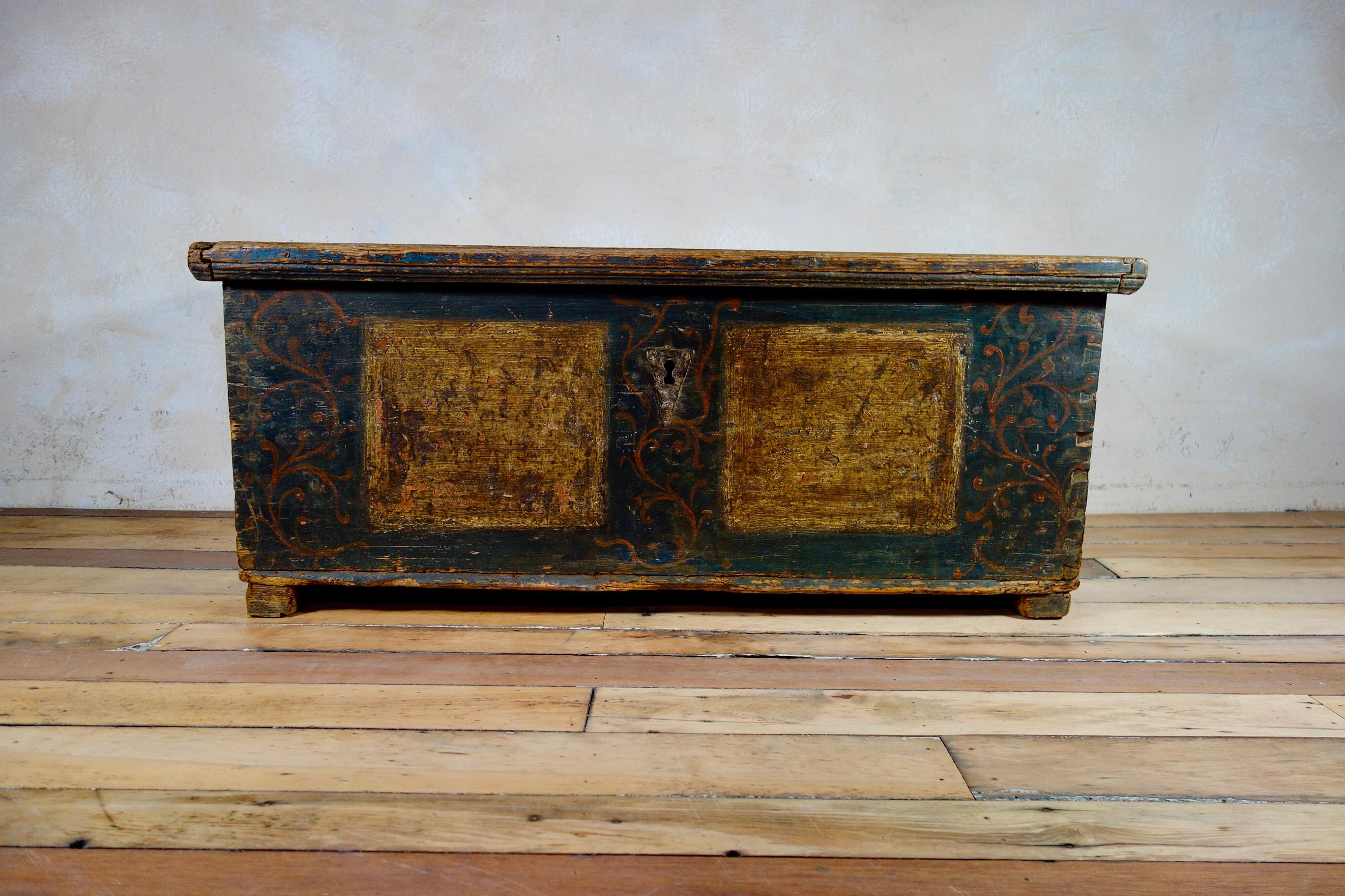An antique hand painted marriage or dowry chest originating from Northern Europe and dating from the late 18th century. Featuring subtle original hand painted decorations to the front and sides of the chest with further faded decorations to the top