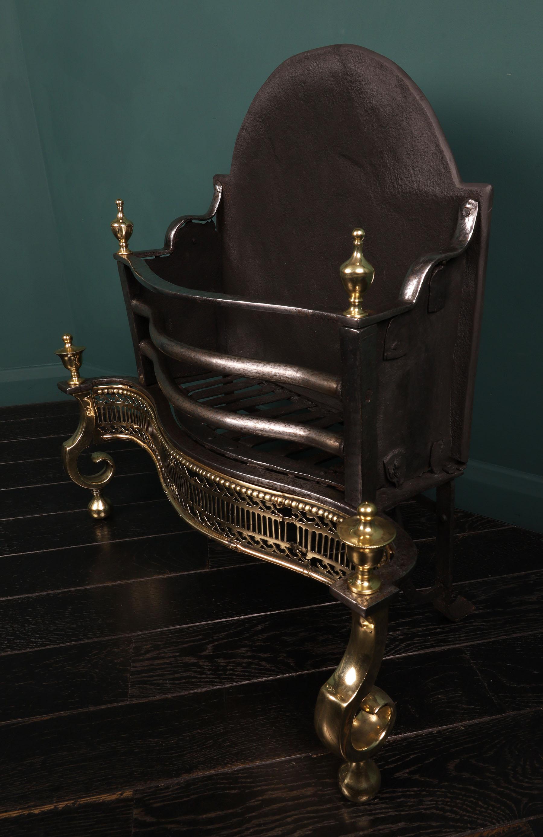 A Late 18th century English Wrought & Brass Fire Basket, the railed front above a fluted brass fret with s-scroll between the scroll standards and urn finials uppermost. Losses to brass fret. Restored.
Height of burning area: 10.

Circa 1790