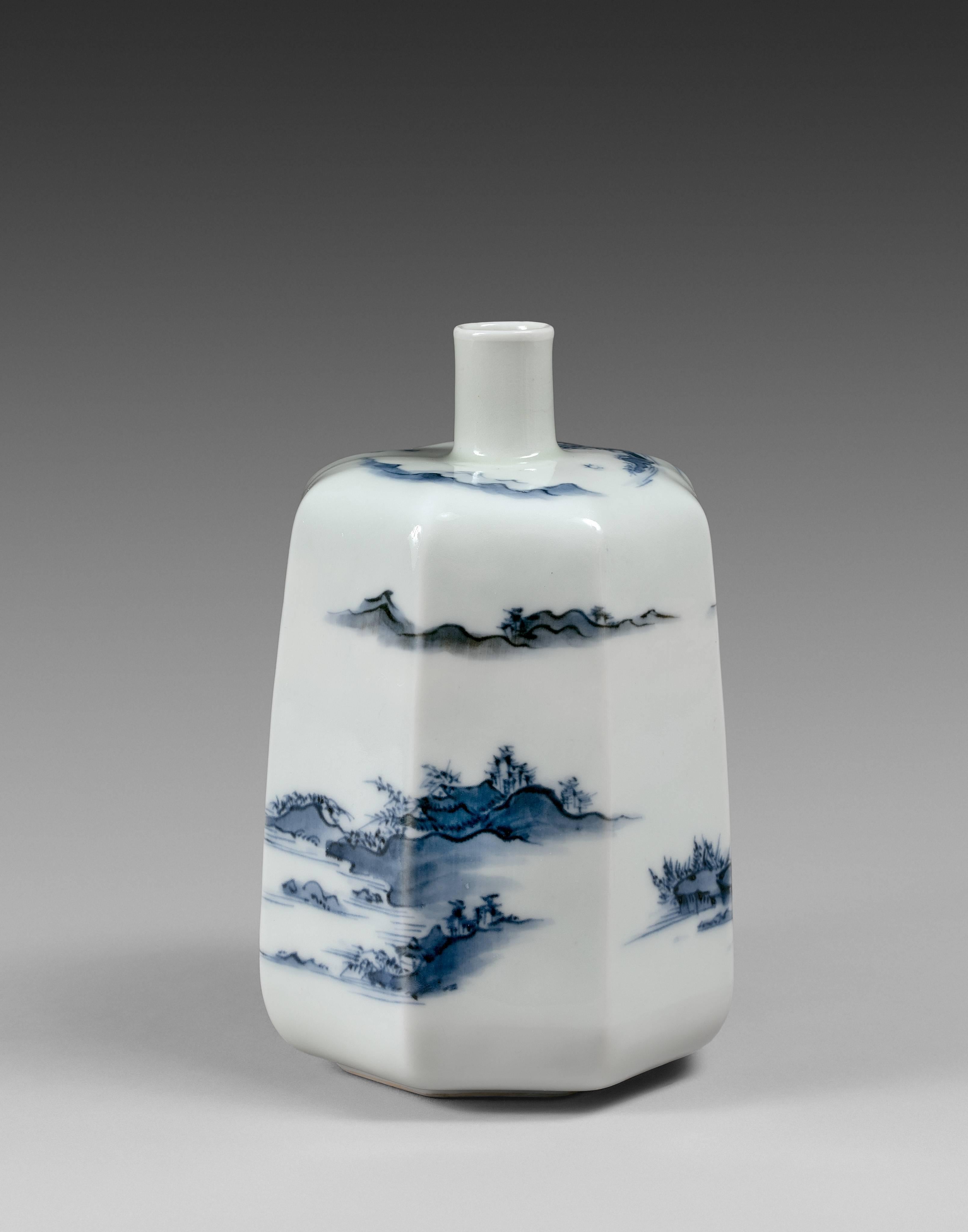 An octagonal shape blue and white porcelain sake bottle, decorated with a continuous Chinese style landscape all over the body and the shoulder, the decoration beautifully conforming to the faceted shape. It is one of the best and earliest example