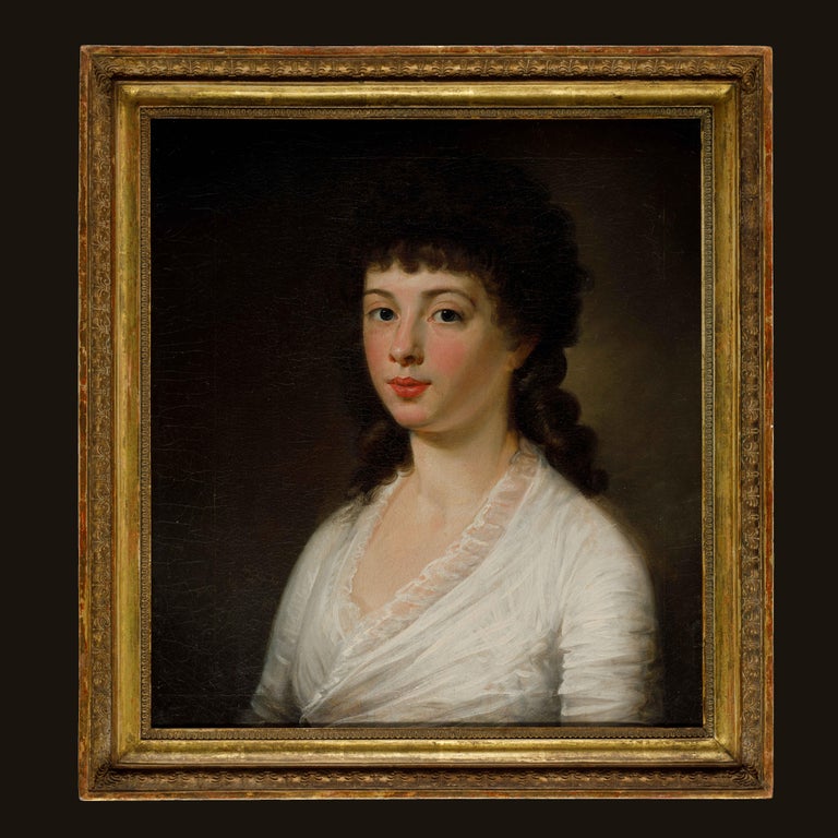 A late eighteenth century portrait of a lady, oil on canvas, in a French Empire 19th century giltwood frame. Attributed to Henri-Pierre Danloux (February 24, 1753 - January 3, 1809).

This fine portrait depicts a young lady wearing a plain, softly
