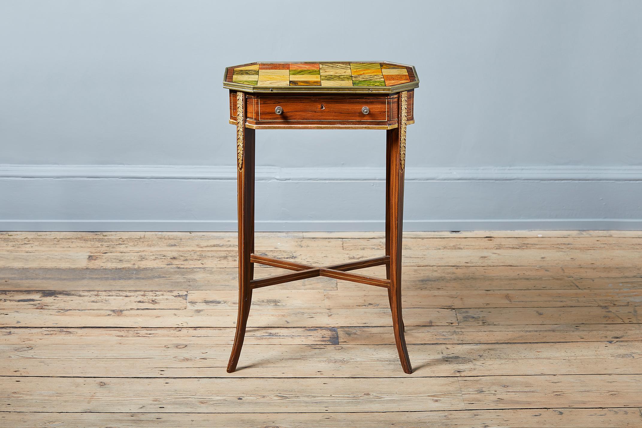 A Regency period occasional table painted to simulate marbles and rosewood, English circa 1790-1810, the canted rectangular top painted in a variety of colors with twenty-four panels to simulate various marbles, with a simulated rosewood outer edge