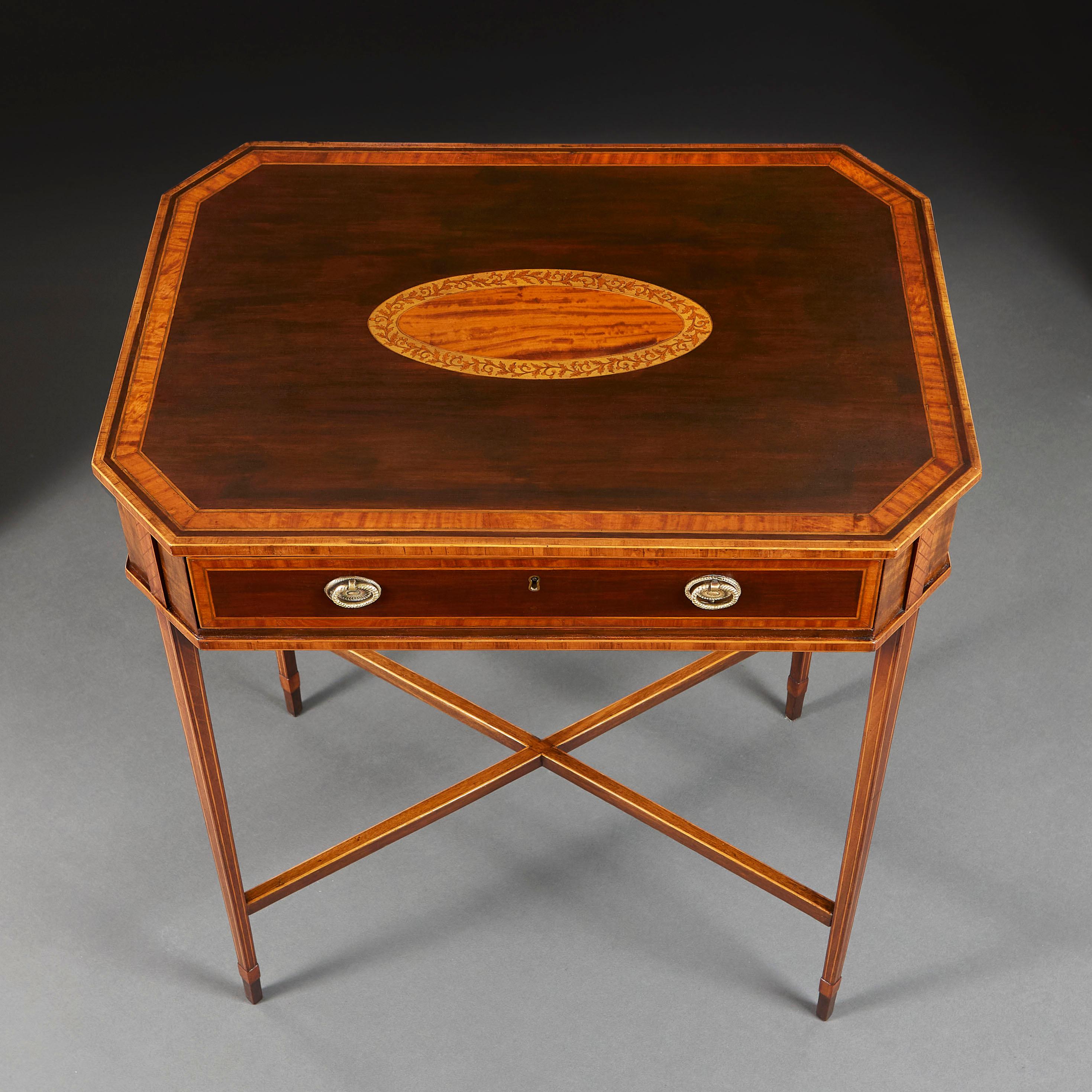 A fine late eighteenth century occasional table, the top with canted sides, constructed from goncalo alves with oval cartouche inlaid with Ceylonese satinwood, surrounded by a banding of interlocking leaves, with single drawer retaining the original