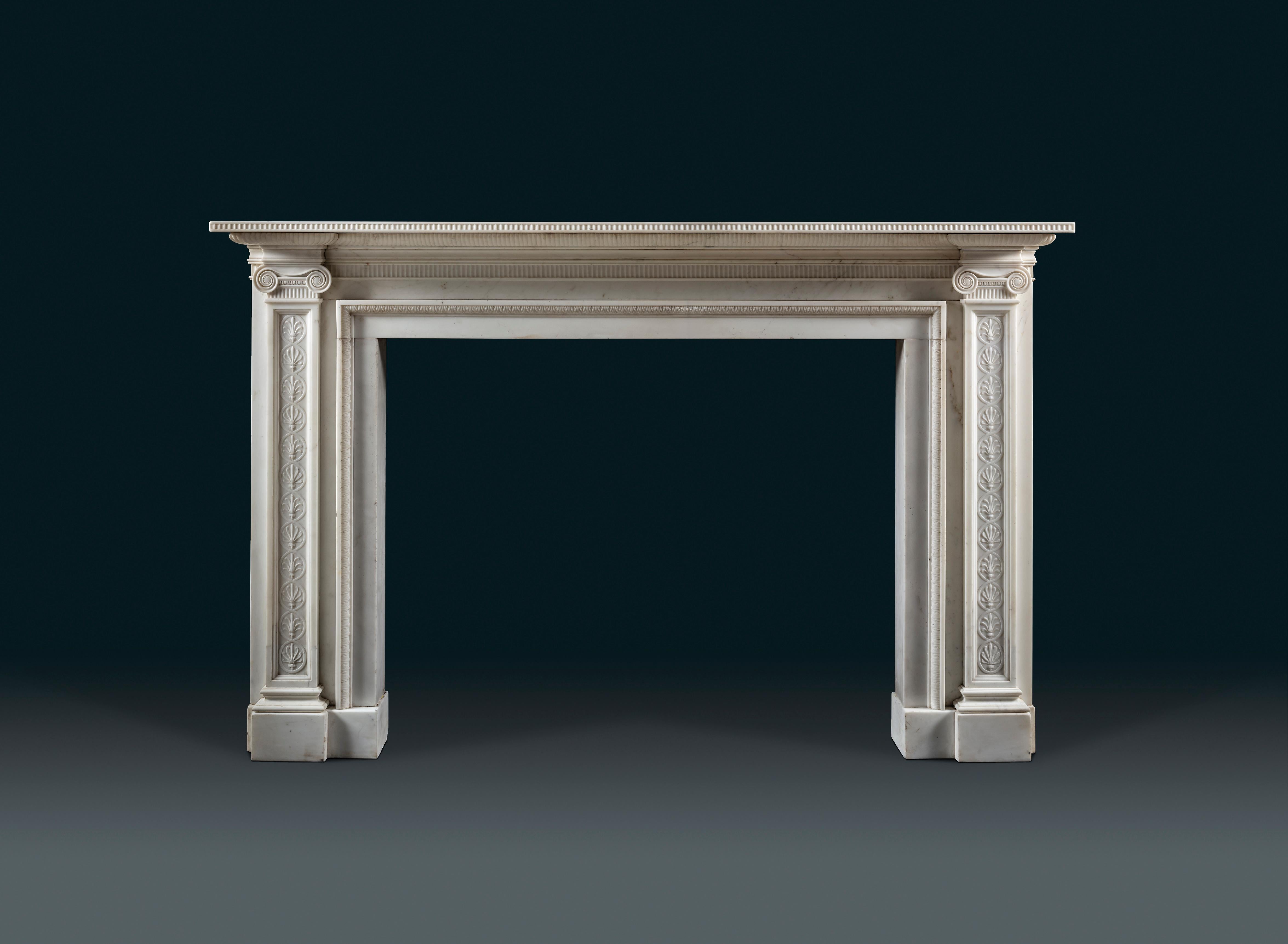 An extremely fine late 18th century Statuary marble chimneypiece of strong architectural character and landscape proportion, after a design by the architect Robert Adam (1728 – 1792). The pilaster jambs are capped by Greek Ionic capitals, possibly