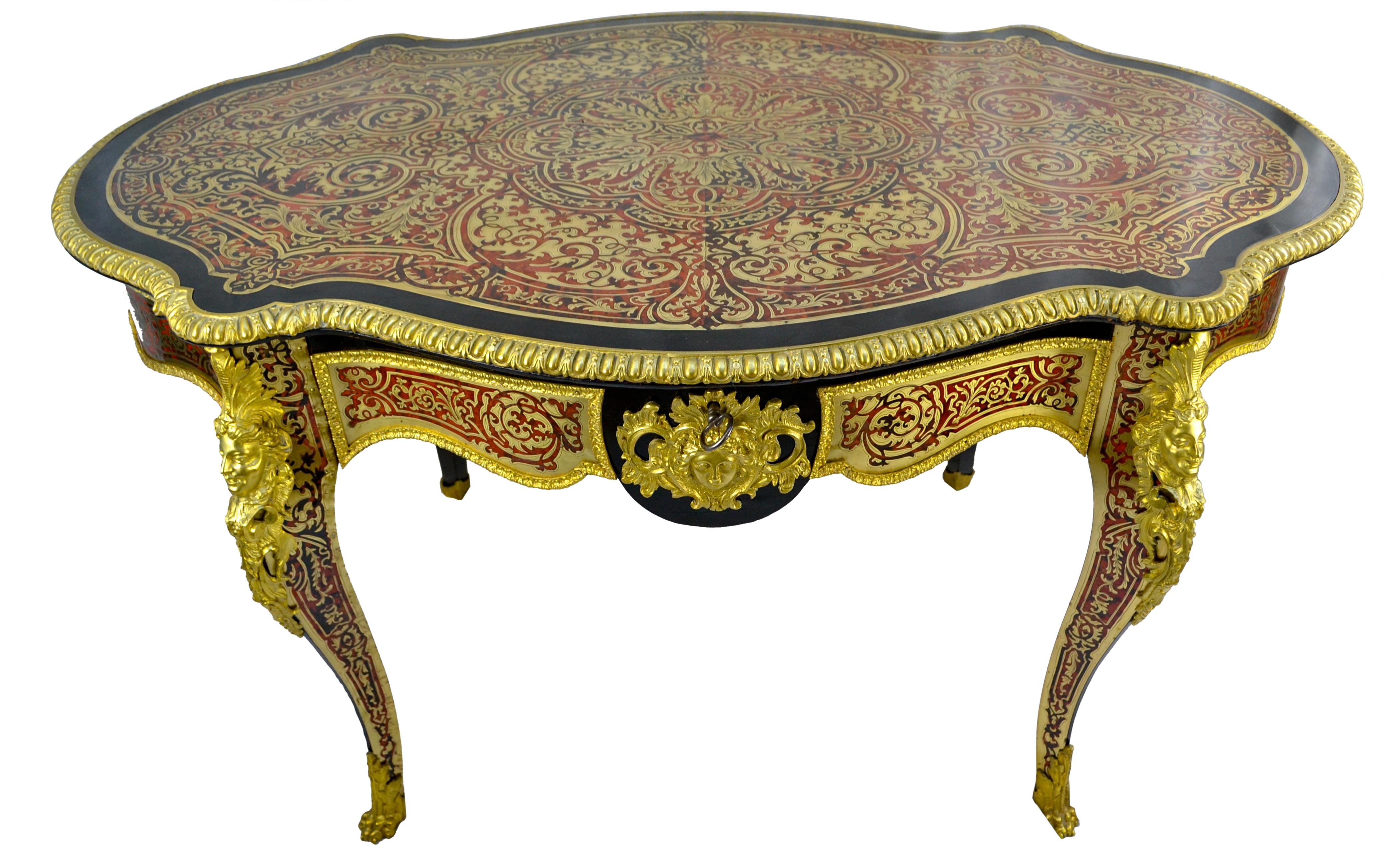 A fine Napoleon III French kidney shaped centre table and desk with overall Boulle work to the oak carcass (tortoiseshell and brass inlay); having a finely chased gilded bronze top border, and gilded bronze mounts to the apron and legs. The shaped