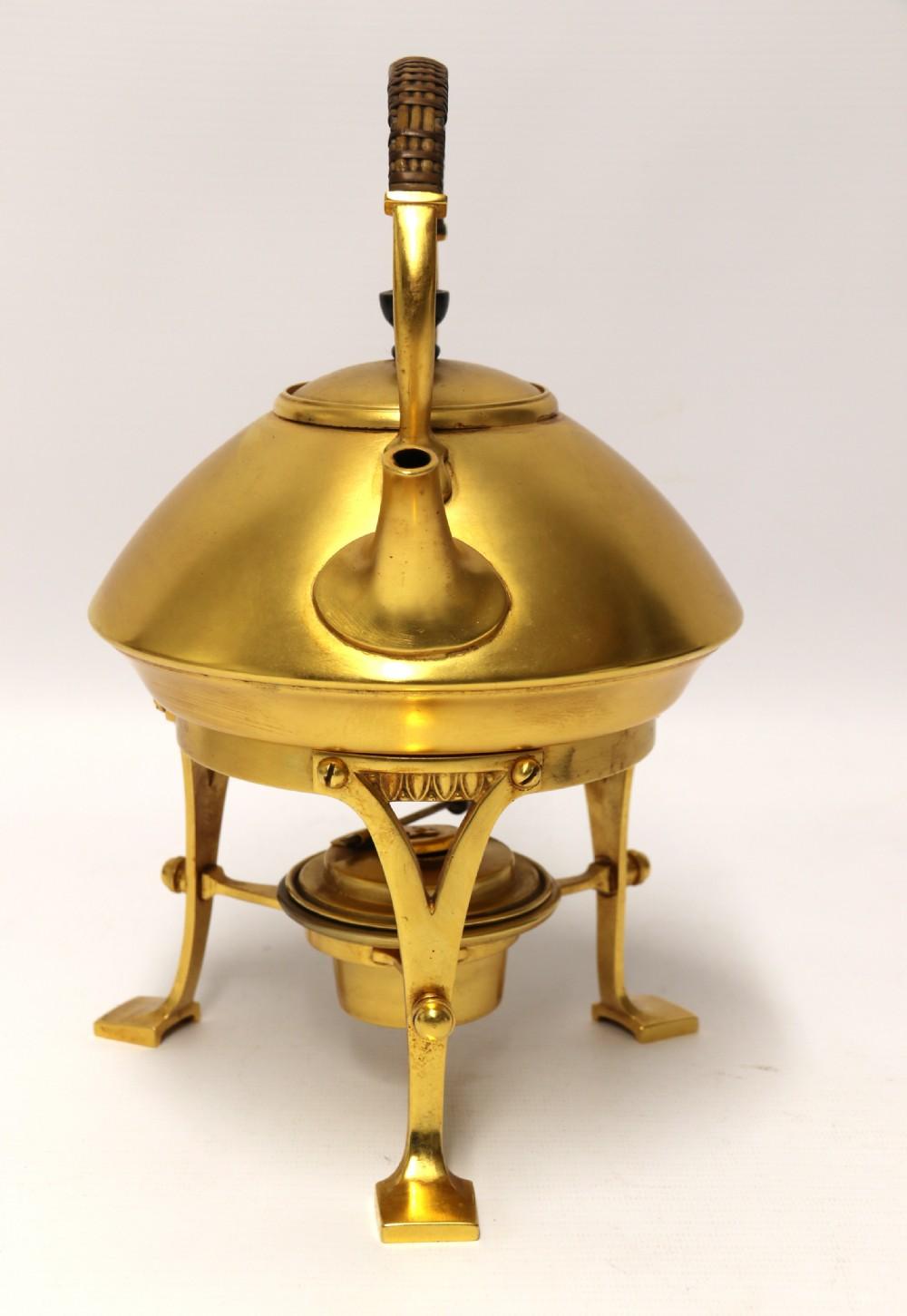 A late 19th century Aesthetic movement Spirit Kettle.
This opulent and beautifully made piece is made from brass with gold plated surfaces which is in excellent condition. It is of a wonderful design, very reminiscent of a piece of Christopher