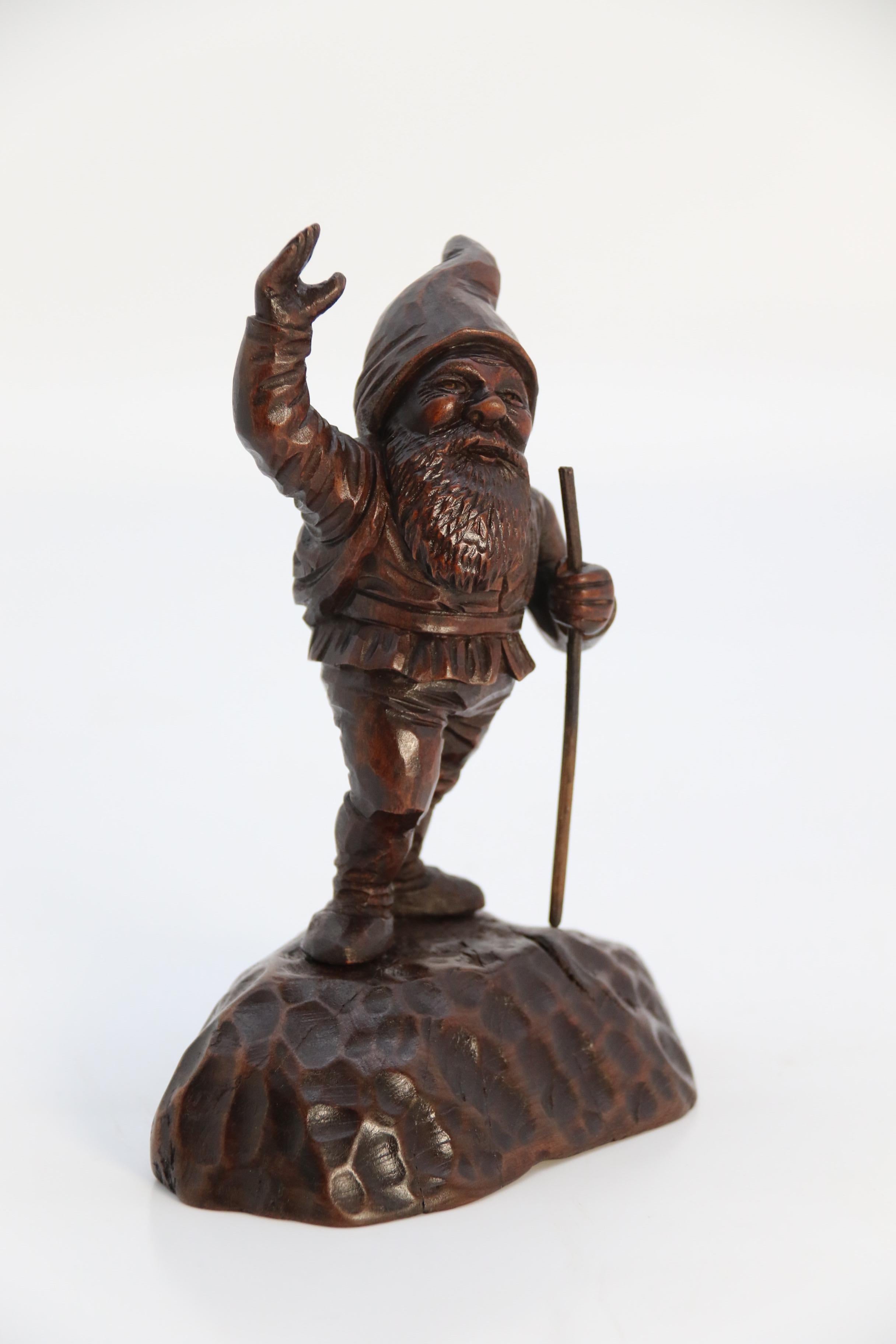 This jolly little chap is very pleasing. He is beautifully hand carved in walnut and was made at the end of 19th century in the Black Forest region of Germany or Switzerland. He is out walking with a stick in one hand and he has reached the top of a