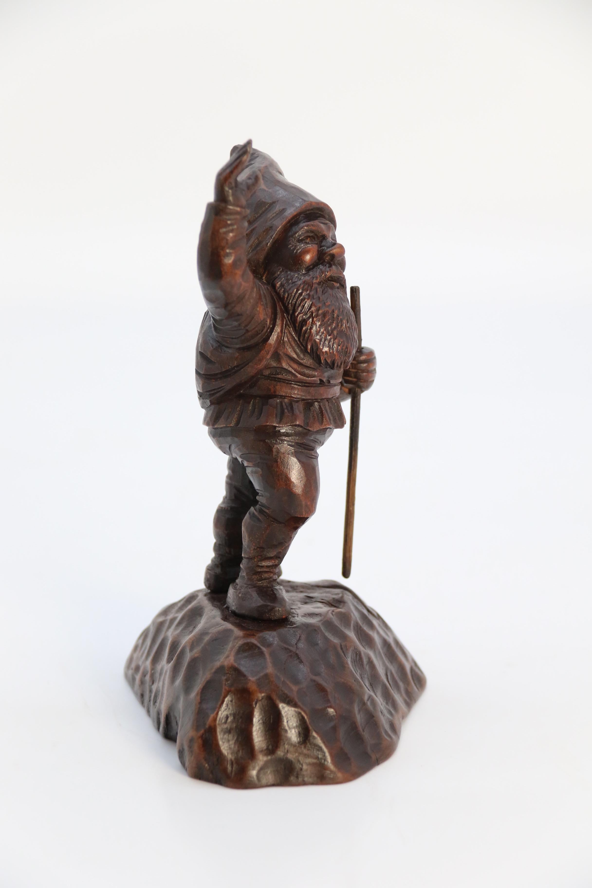 Swiss A late 19th century Black Forest carved walnut figure of a gnome circa 1900