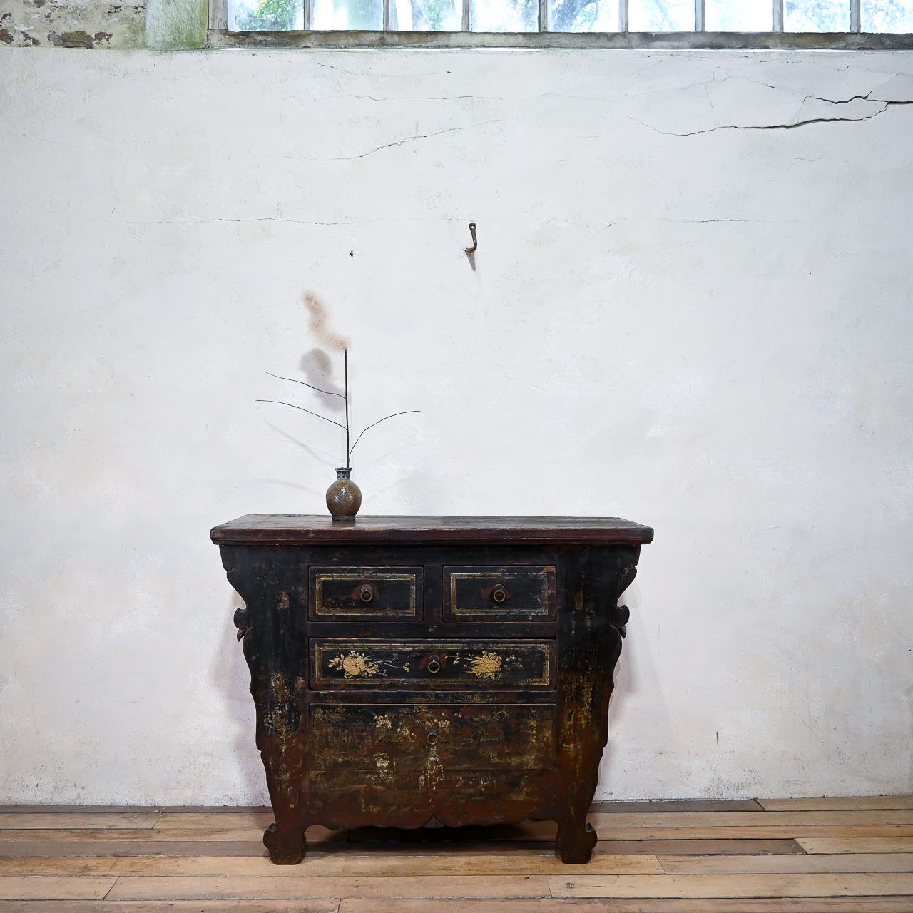 a captivating late 19th-century Chinese butterfly cabinet, a traditional altar coffer originating from Shanxi Province. Crafted from elm wood, this exquisite piece showcases painted details adorning the drawer fronts and cupboard doors, depicting