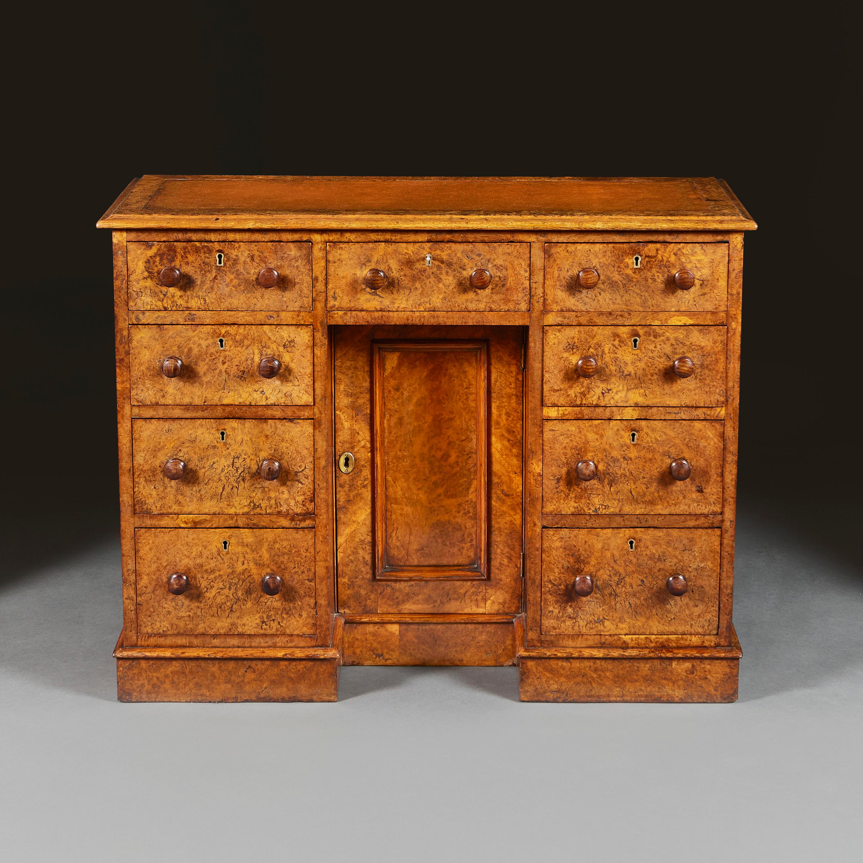England, circa 1880

A late 19th century burr oak kneehole desk, opening with nine drawers to the front, with central cupboard, the top with leather writing surface with gilt tooled border, the sides and back with moulded cartouches.

Height