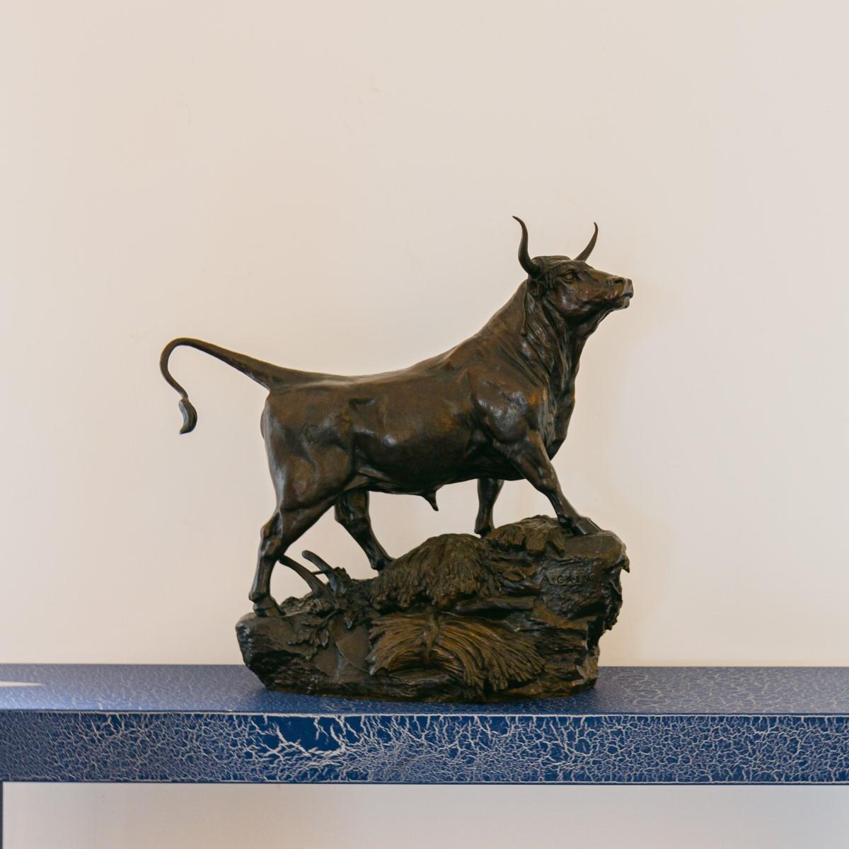 A late 19th century French patinated bronze model of a bull standing amongst an overturned wheat cart, on a rocky outcrop by Auguste Nicolas Cain. 

The bull has been branded with the sculptors initials 'AC' and also signed 'A. Cain' to the rocks.