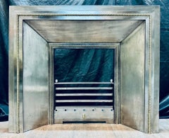 A Late 19th Century French Splayed Steel and Brass Fireplace Insert.