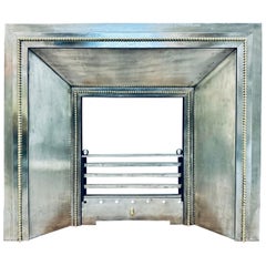 Used A Late 19th Century French Splayed Steel and Brass Fireplace Insert.