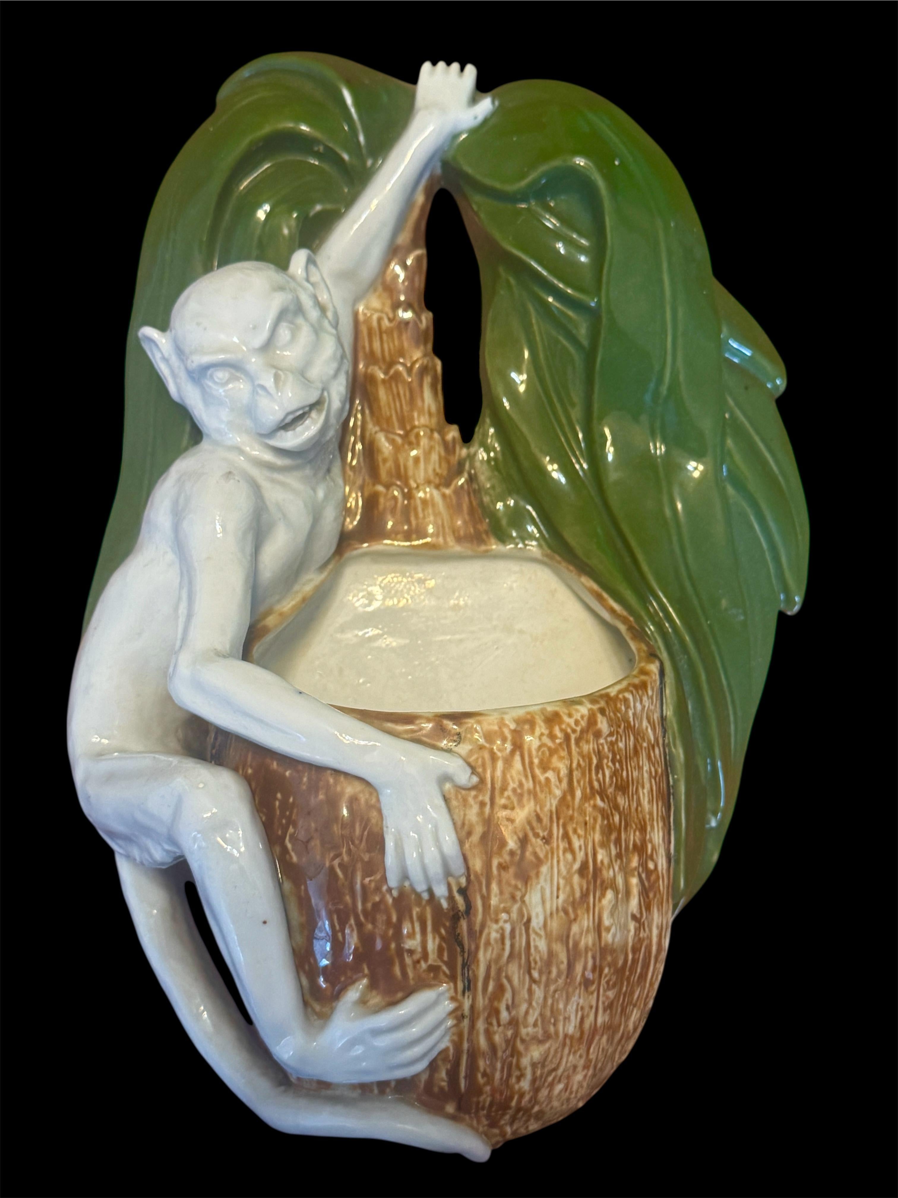 Cette rareté et cette  Sitzendorf très particulier  Support mural en porcelaine allemande datant d'environ 1870-1880, représentant un singe agrippant une noix de coco, avec une plaque arrière en forme de palmier. La noix de coco forme une pochette