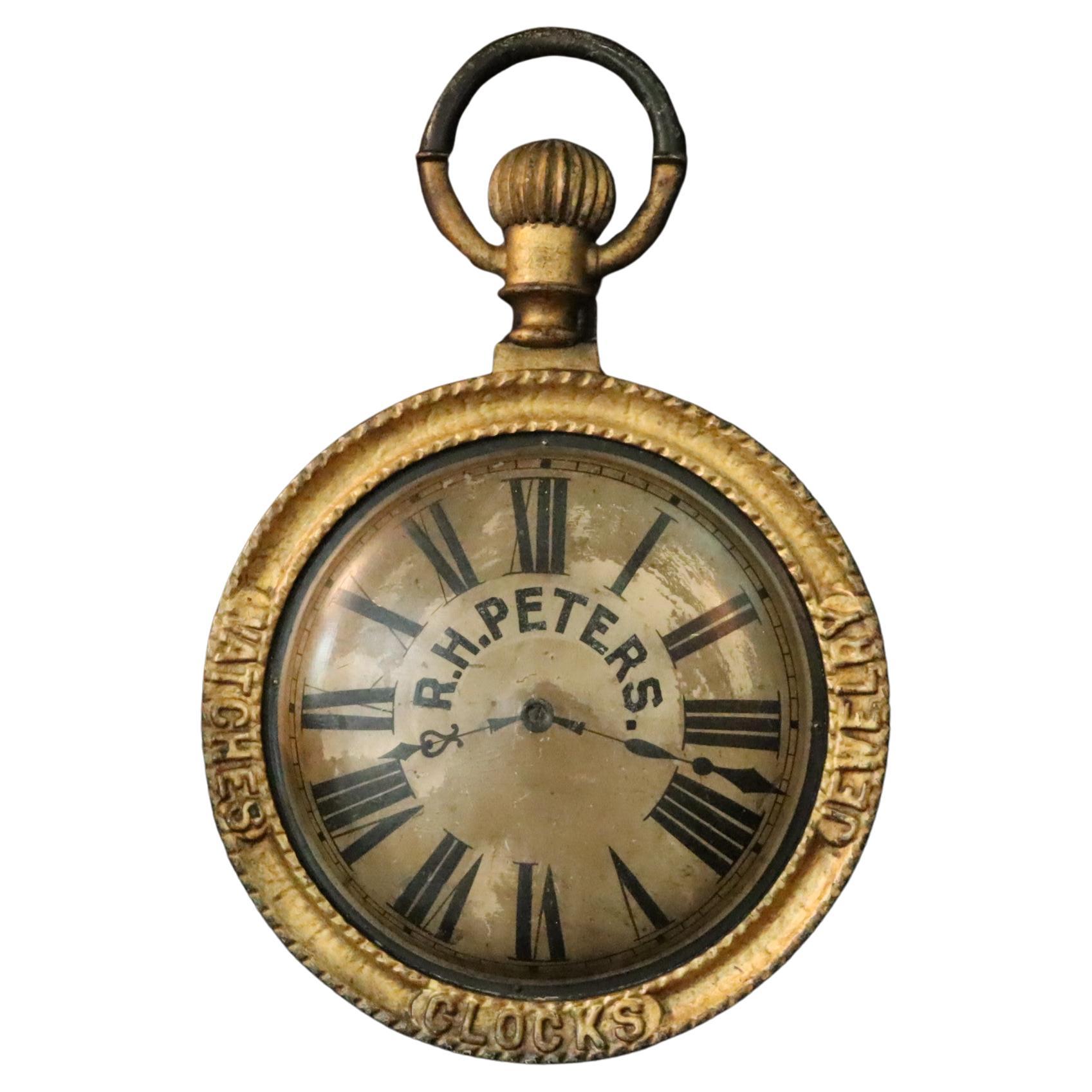 A late 19th Century hanging trade sign, modeled as a Pocket watch.