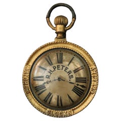 A late 19th Century hanging trade sign, modeled as a Pocket watch.