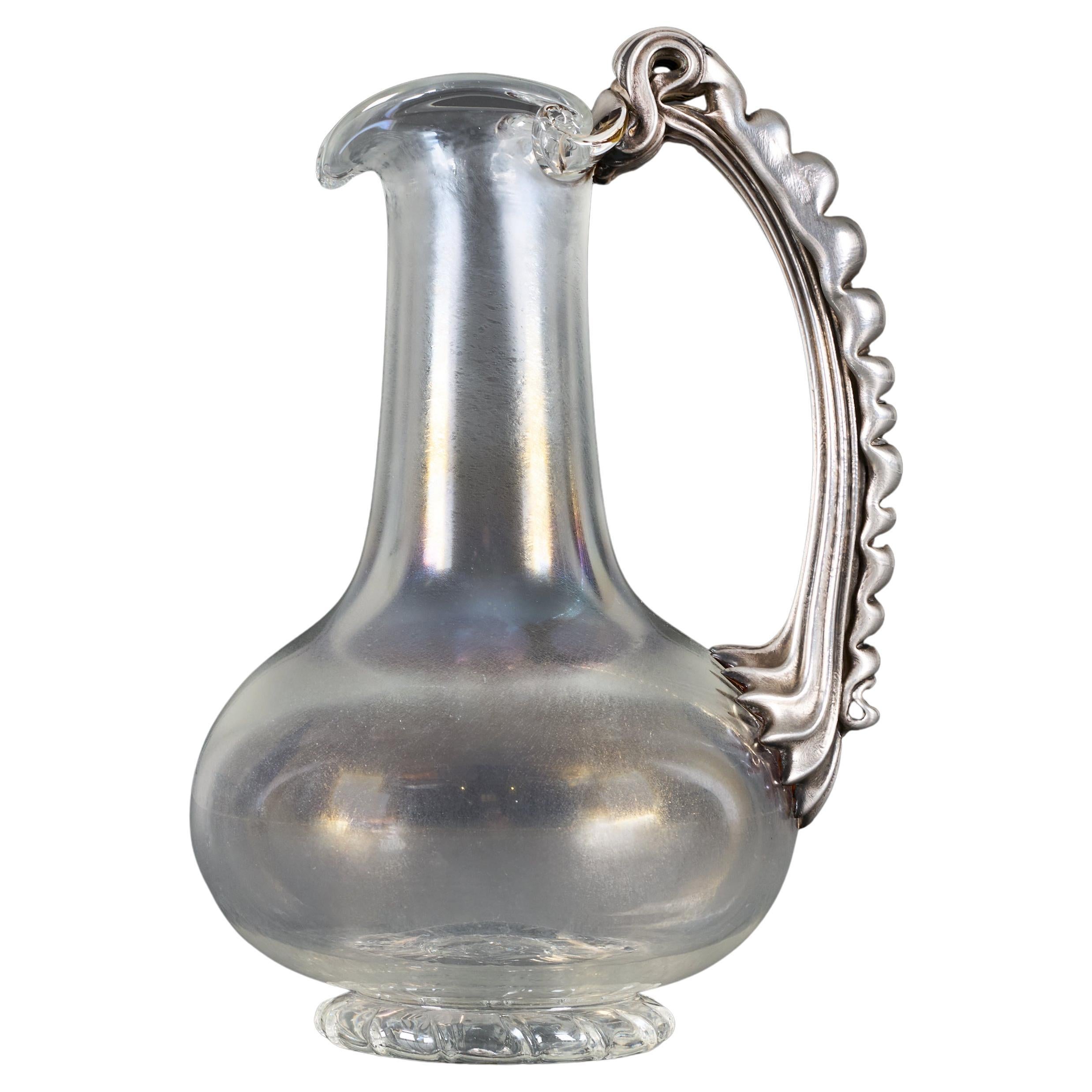 A late 19th Century Iridescent Glass Water Jug with Silver Handle For Sale