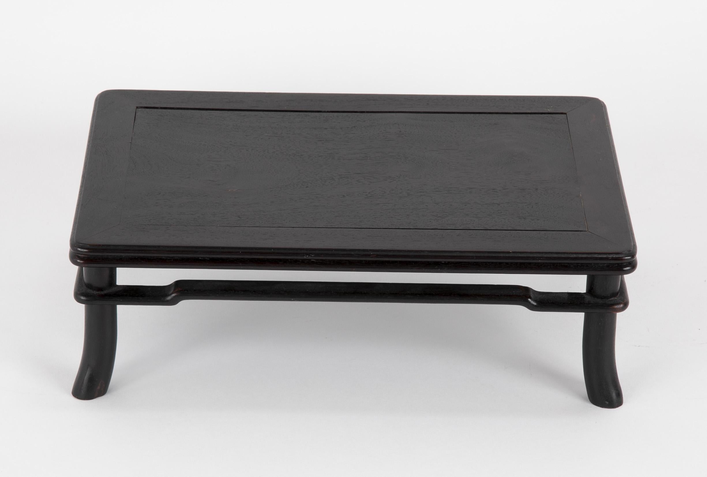 An Zitan wood low table / stand. Late 19th century Japanese Meiji Period. Zitan is an extremely dense wood which sinks in water. It is a member of the rosewood family. The wood is blackish-purple to blackish-red in color, and its fibers are laden