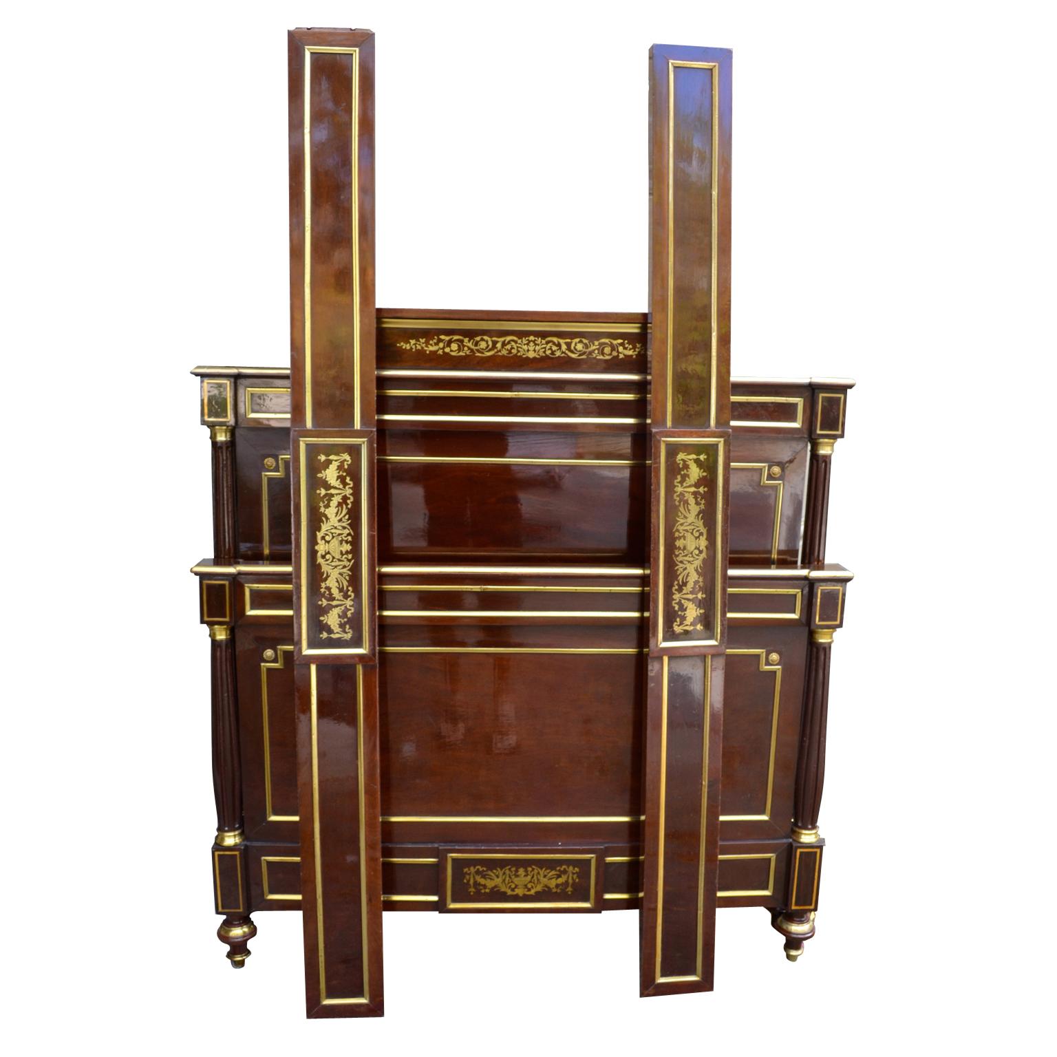A fine Louis XVI style mahogany and brass inlaid three quarter size bed, French late 19th century, with rails, a raised flat crest and fluted side pillars with brass capitals and pediments. The head board, footboard and siderails have all been
