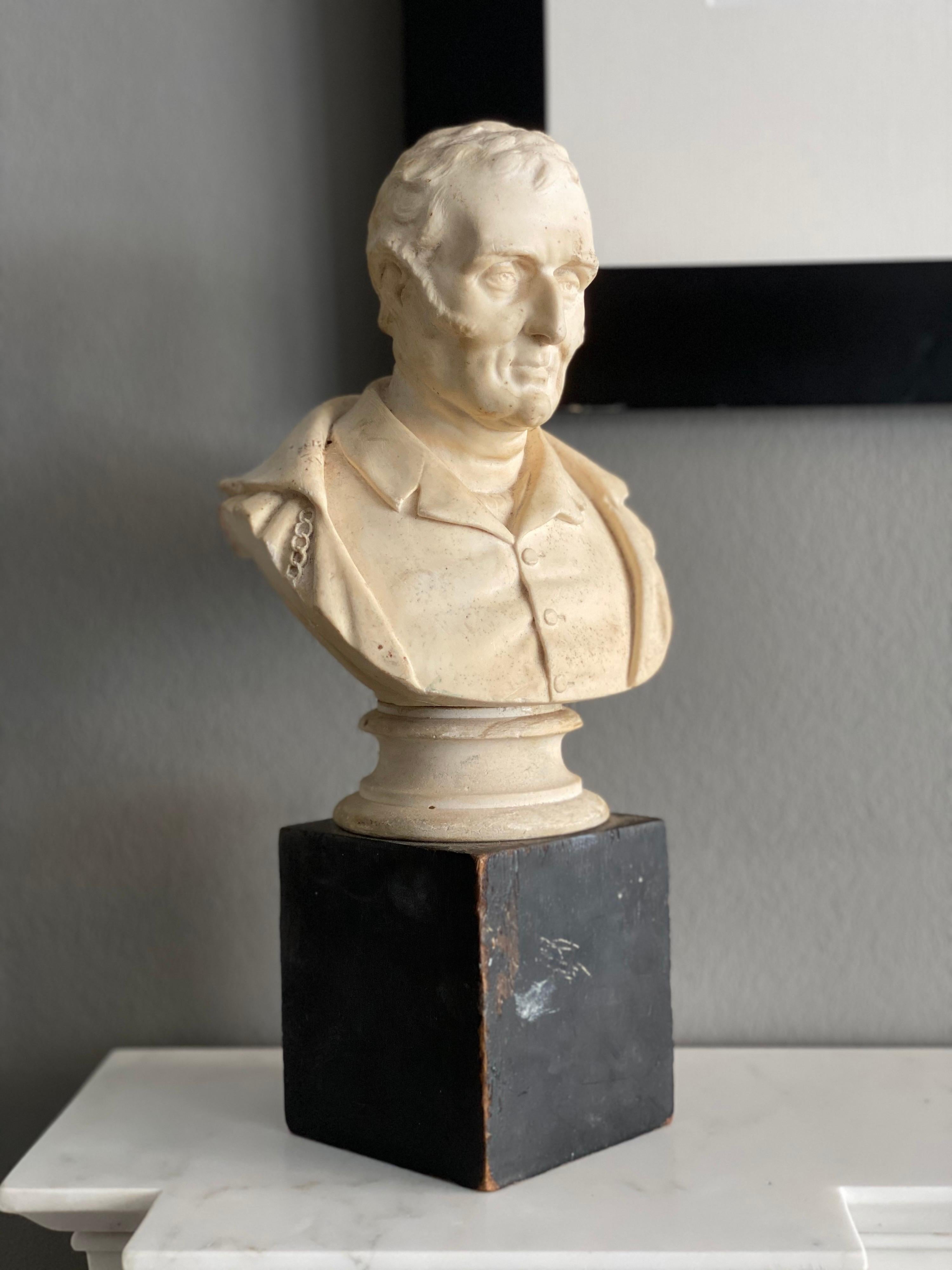 A late Victorian plaster bust of The Duke of Wellington mounted on a simple wooden block.